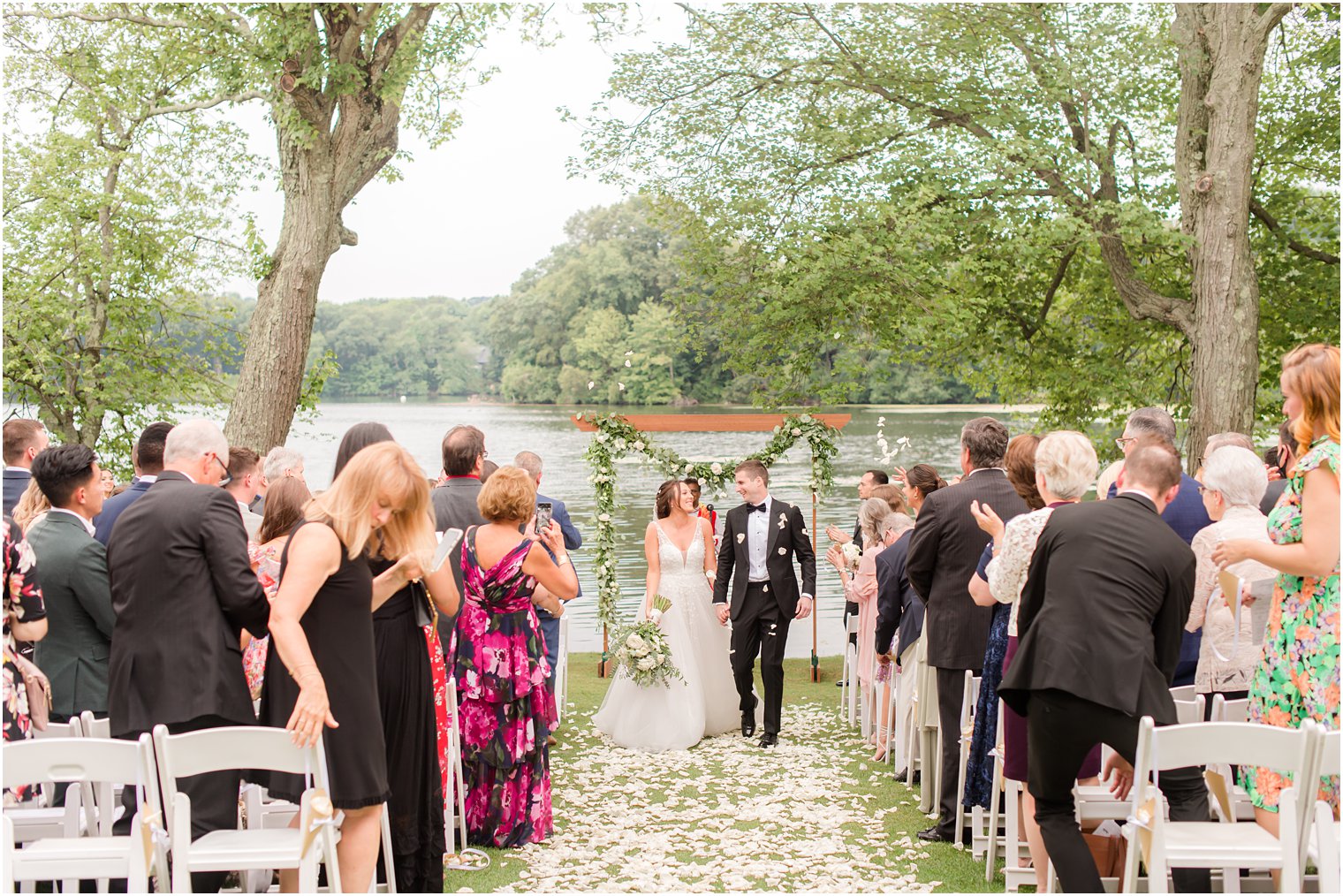 bride and groom walk up aisle during waterfront wedding ceremony in Franklin Lakes NJ