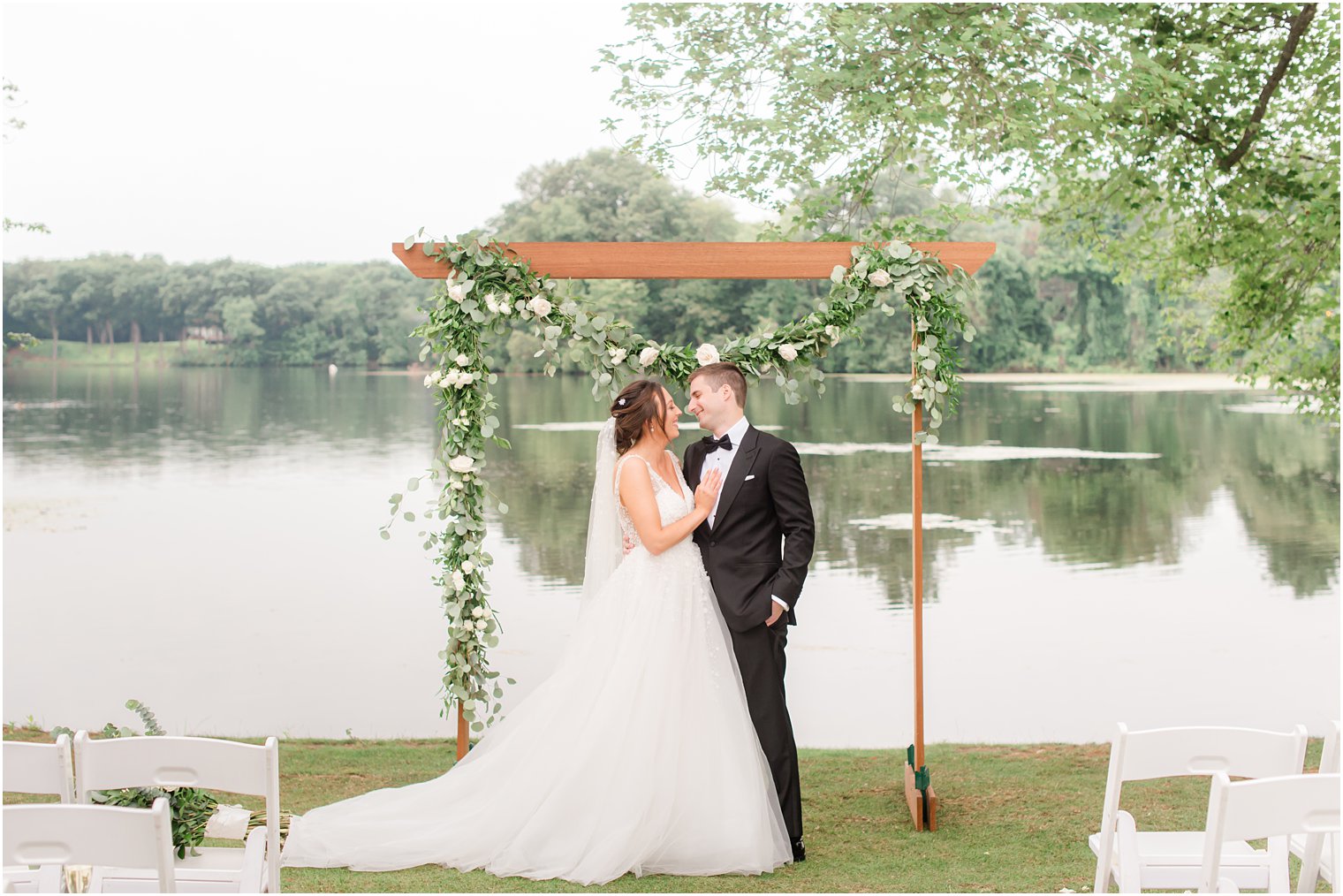 bride and groom pose by wooden altar in New Jersey 