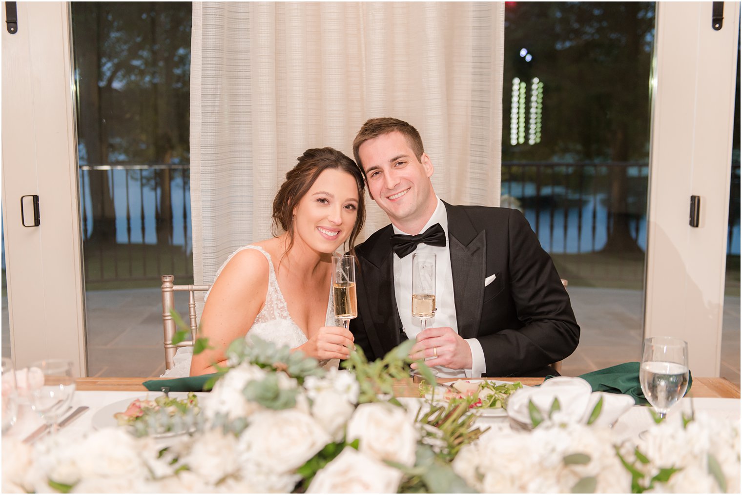 bride and groom sit together at sweetheart table for Franklin Lakes NJ wedding reception