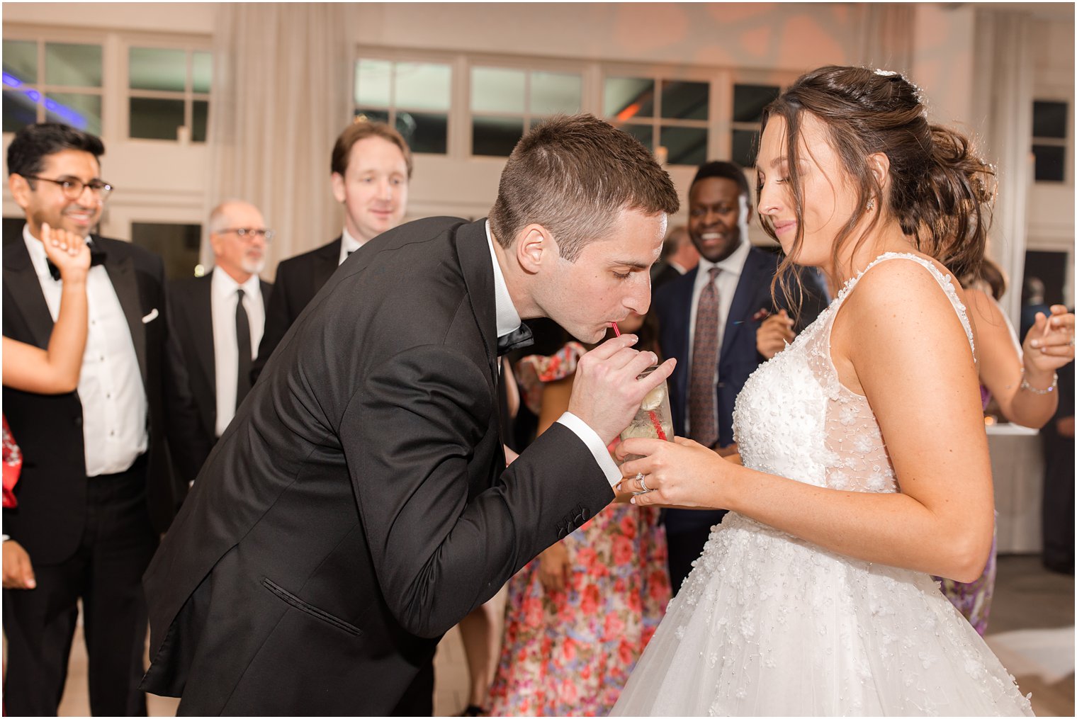 groom drinks from cup at Franklin Lakes NJ wedding reception