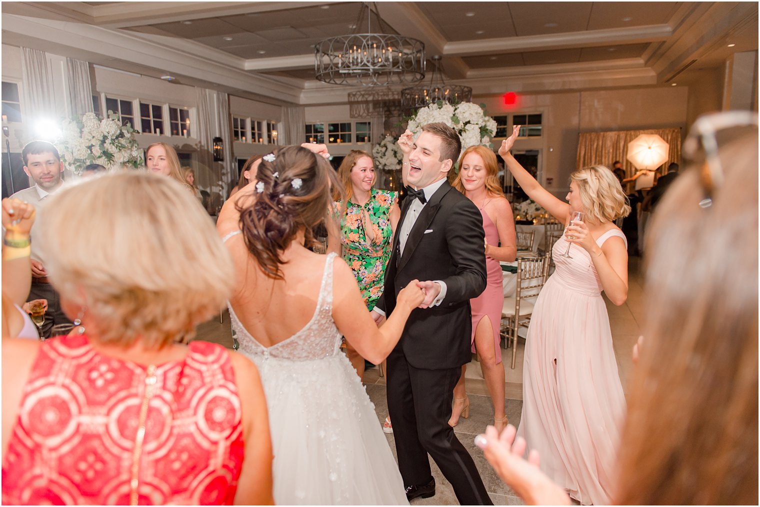 groom laughs during NJ wedding reception