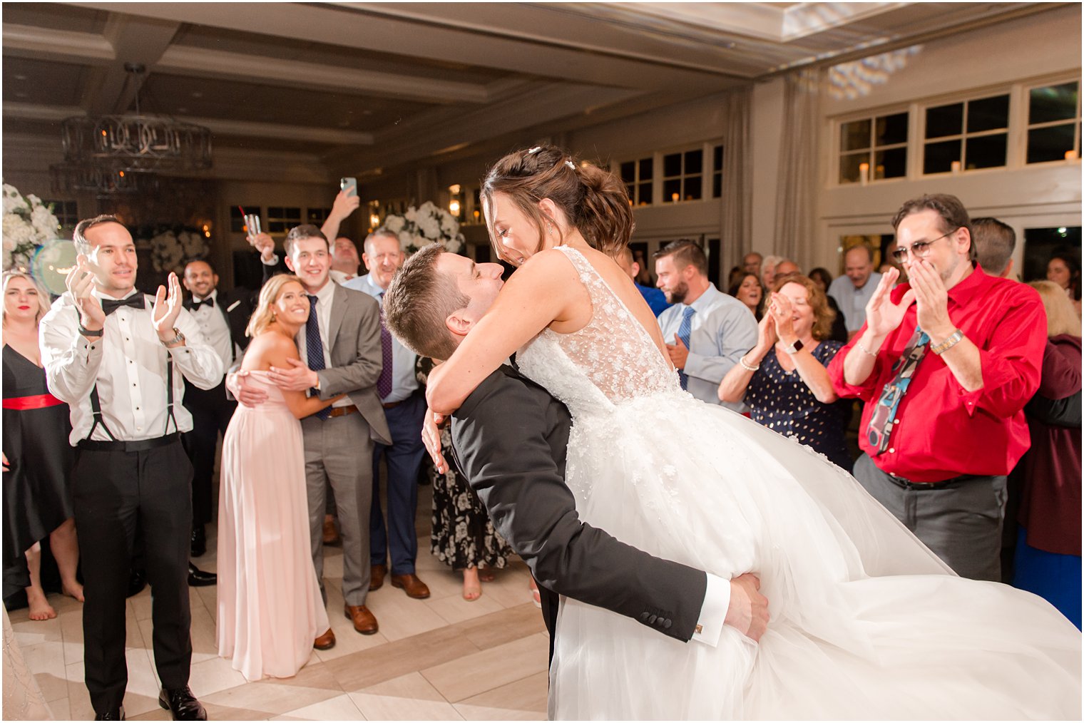 groom lifts bride during NJ wedding reception
