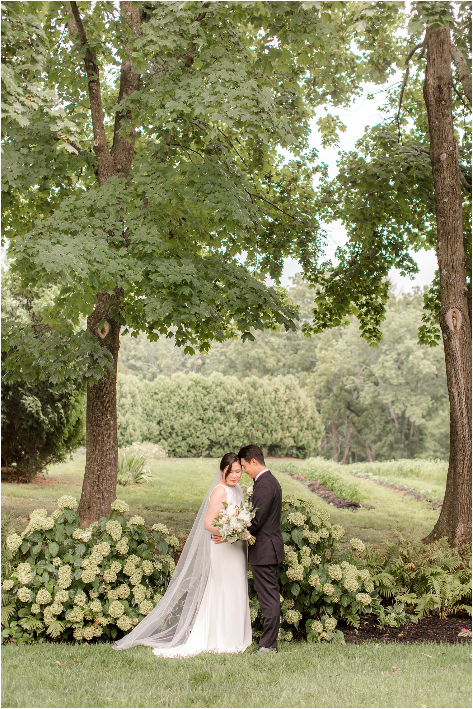 groom leans head against bride's forehead during NJ wedding photos