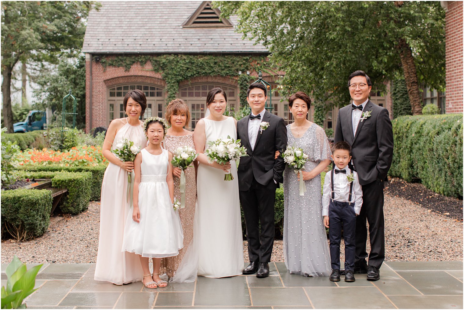 bride and groom pose with family during microwedding at Ninety Acres