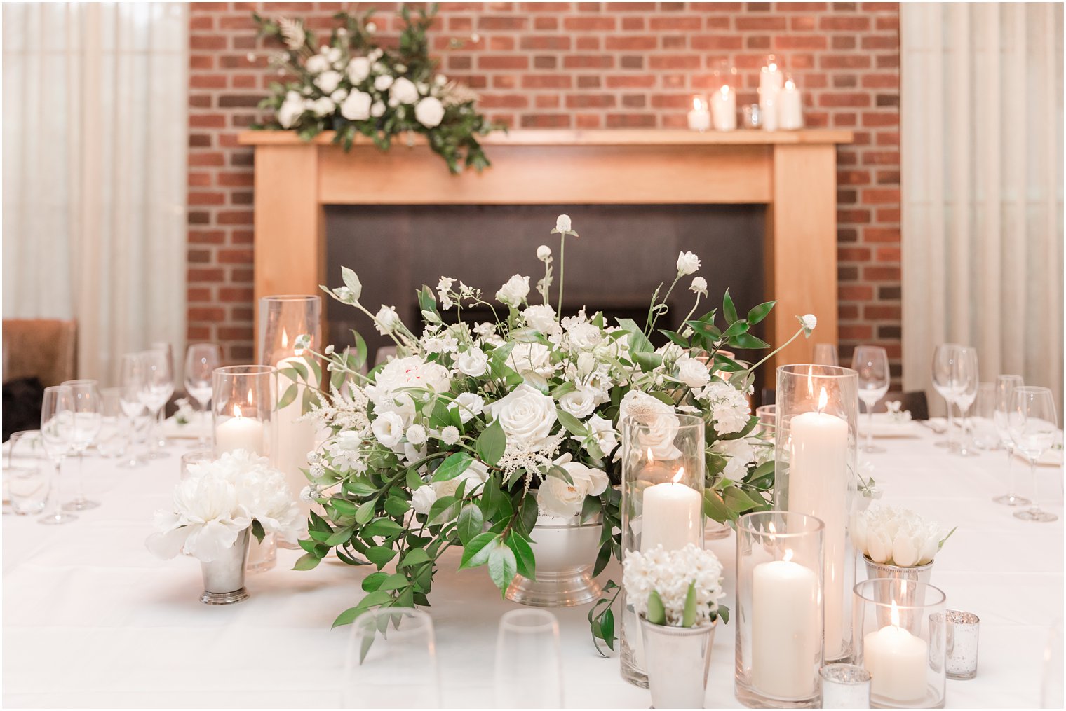 ivory floral centerpiece with candles for microwedding at Ninety Acres