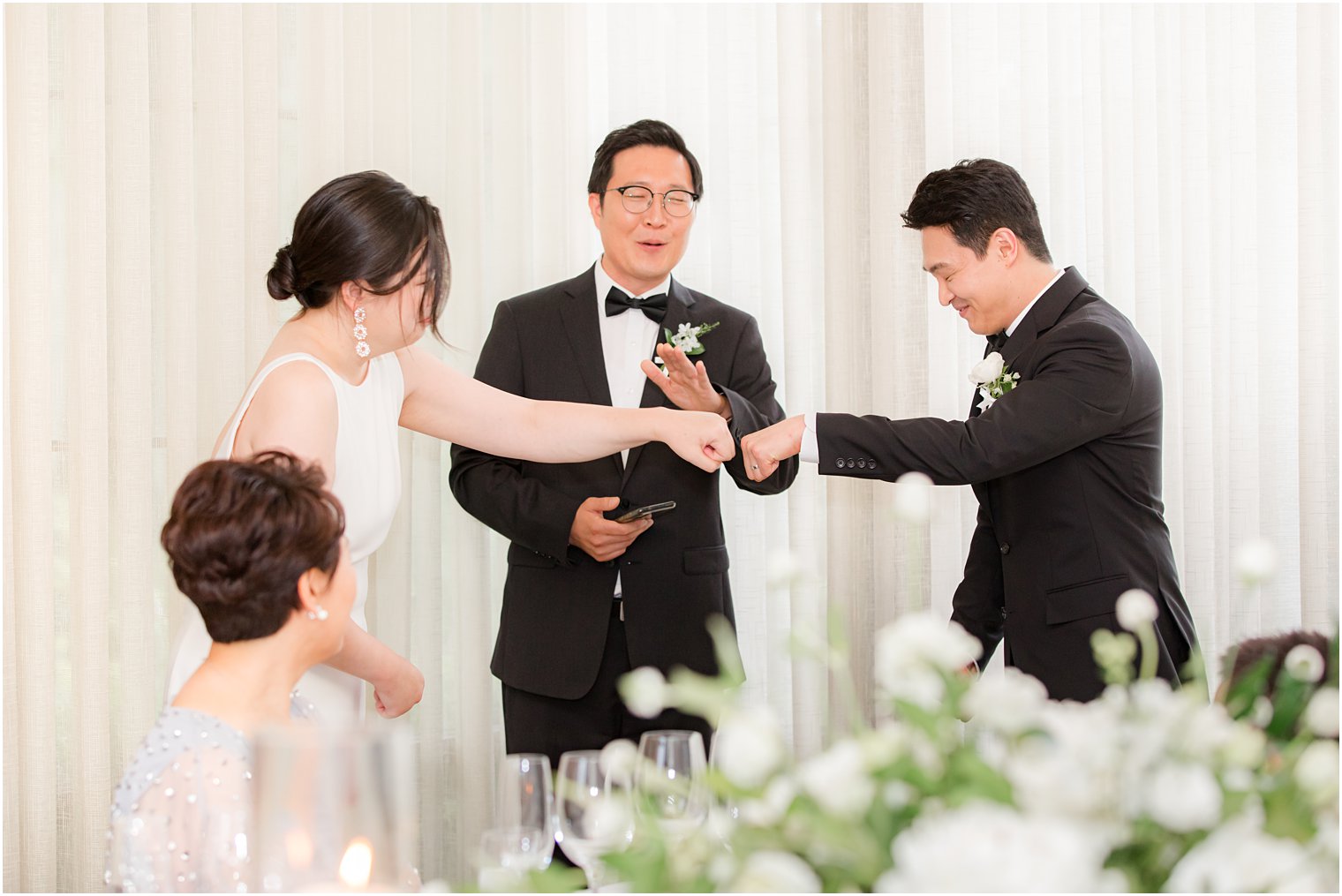 bride and groom fist bump during NJ wedding reception