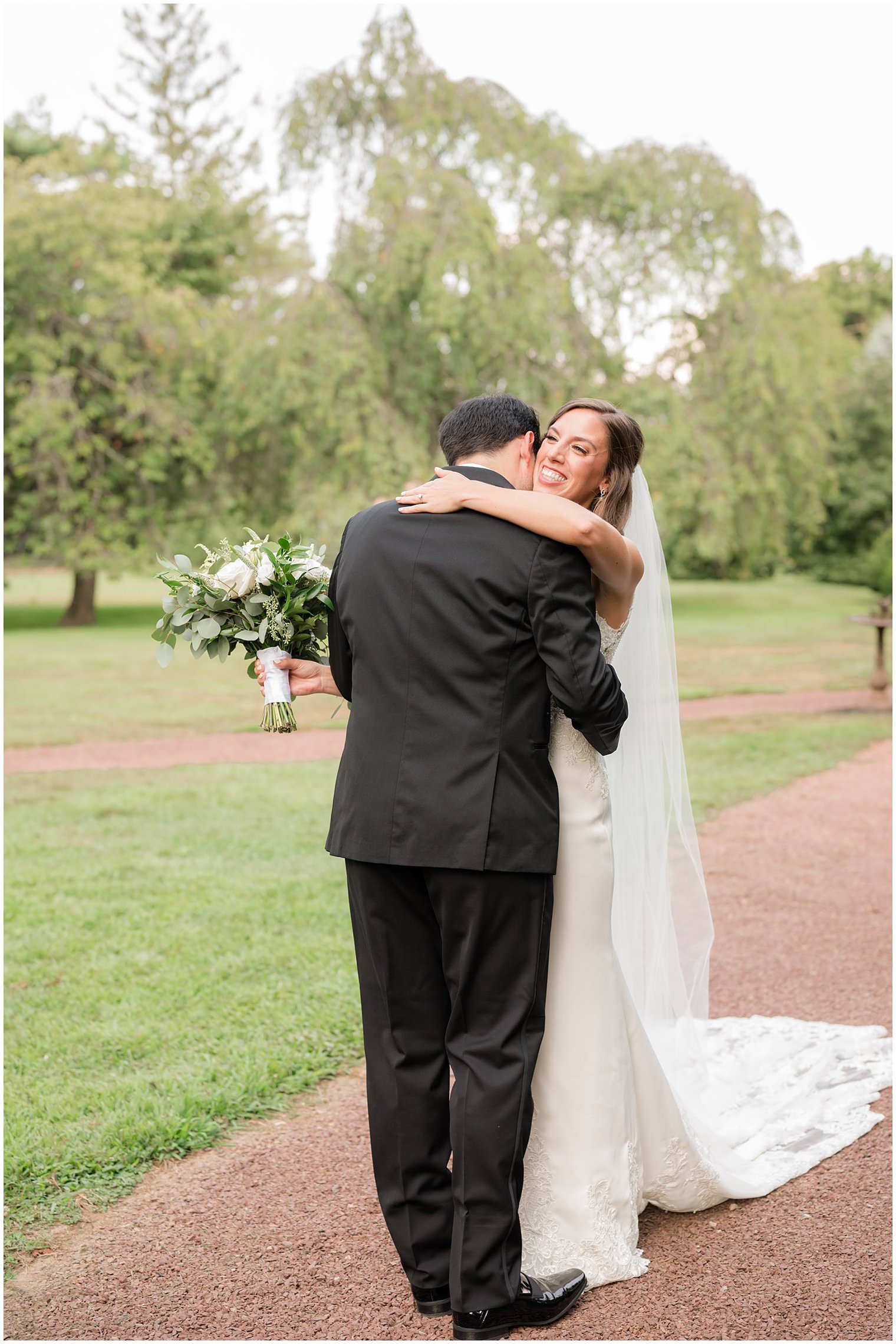 bride and groom hug during first look at the Inn at Fernbrook Farms