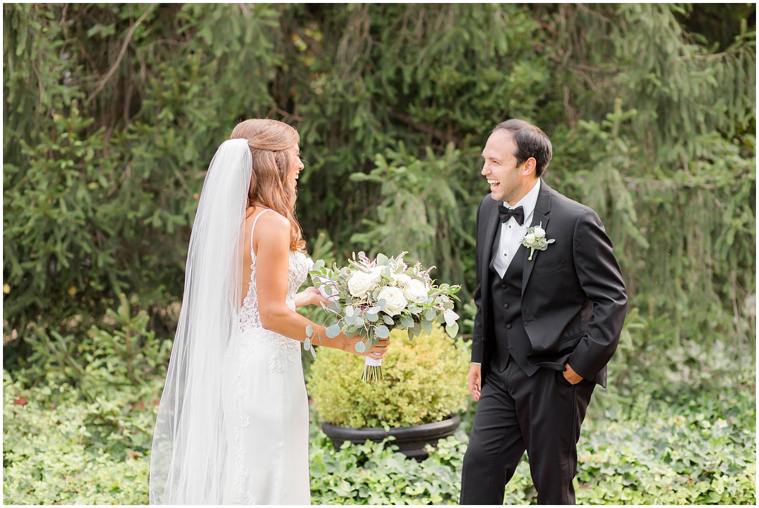 newlyweds laugh during first look at the Inn at Fernbrook Farms