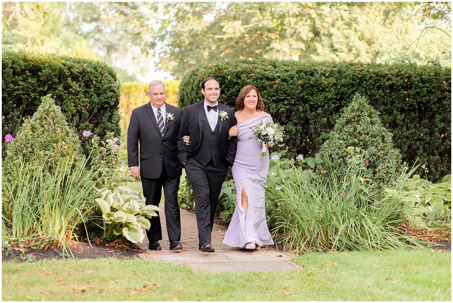 groom walks down aisle with parents for Inn at Fernbrook Farms wedding ceremony