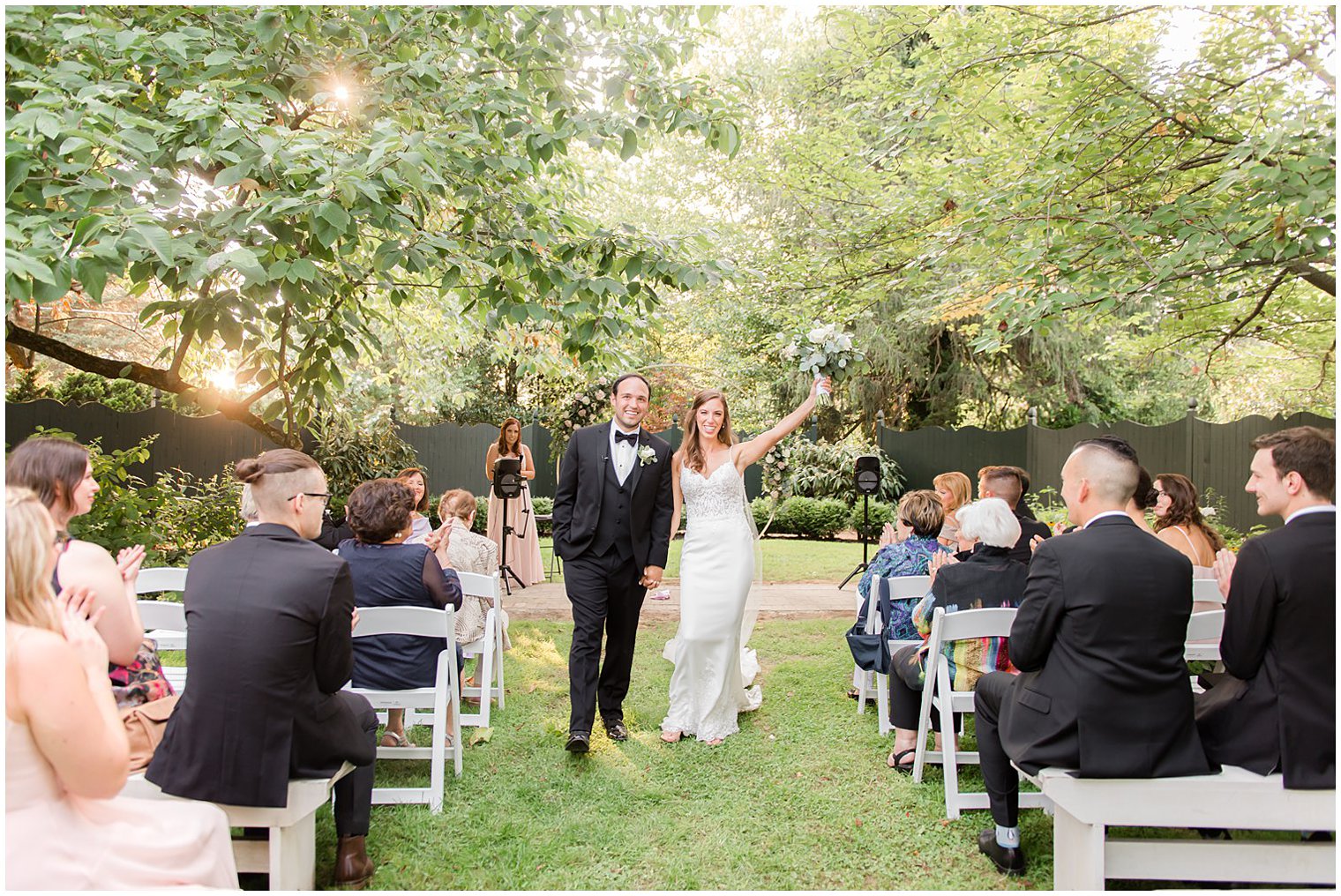 bride and groom cheer leaving wedding ceremony