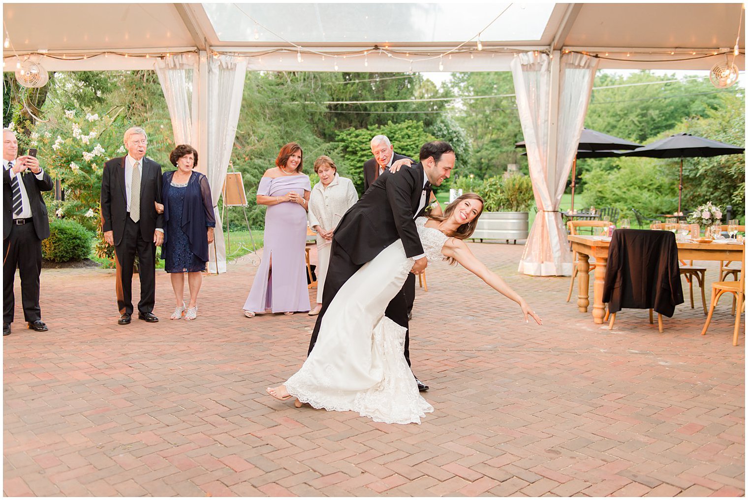 groom dips bride during first dance