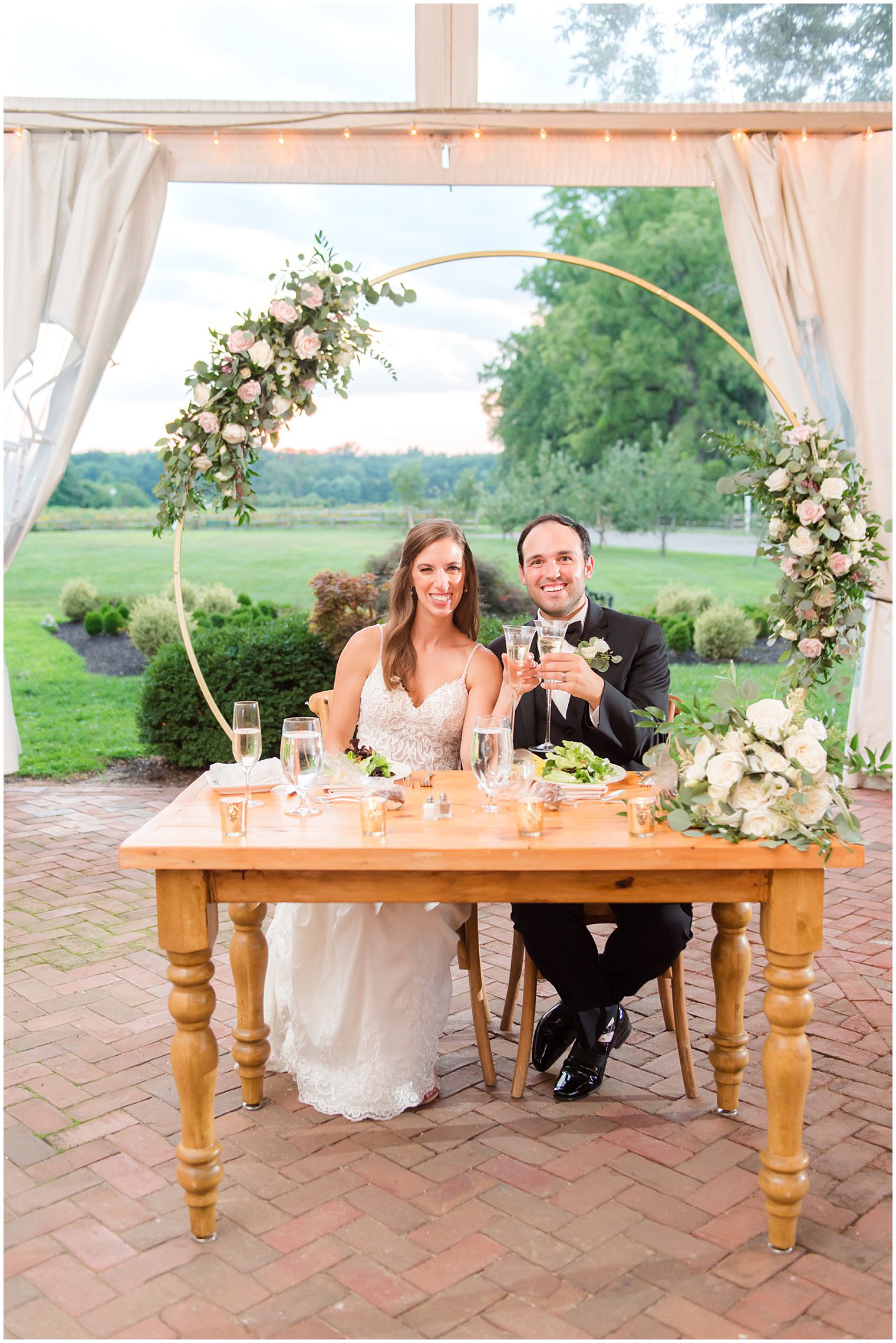 newlyweds toast champagne at sweetheart table during Chesterfield NJ wedding reception