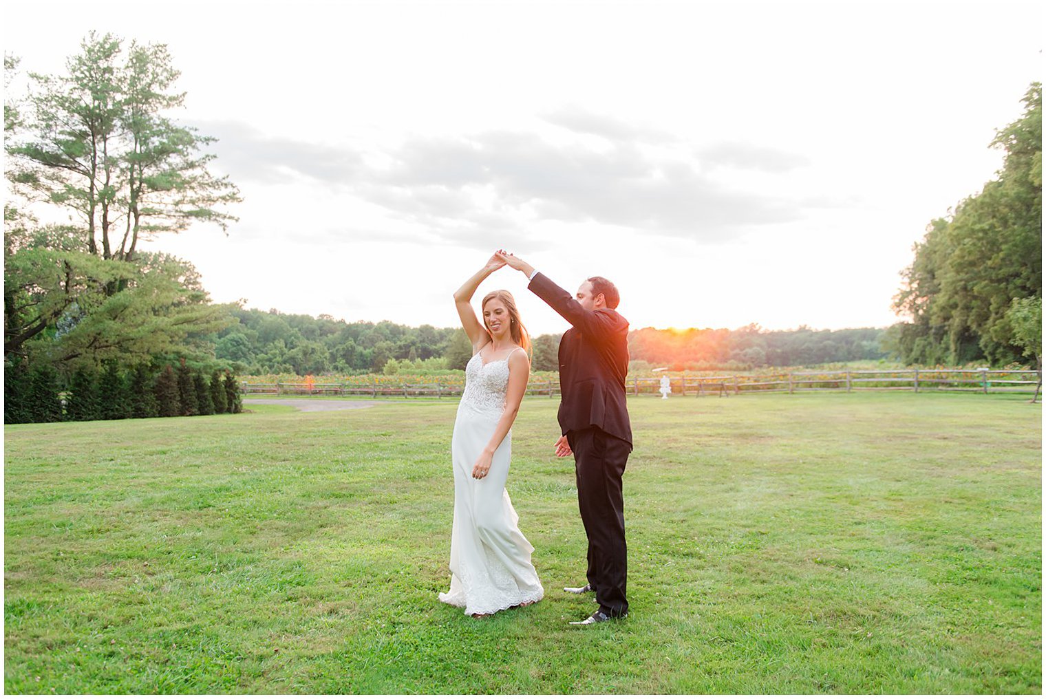 groom twirls bride at sunset at the Inn at Fernbrook Farms
