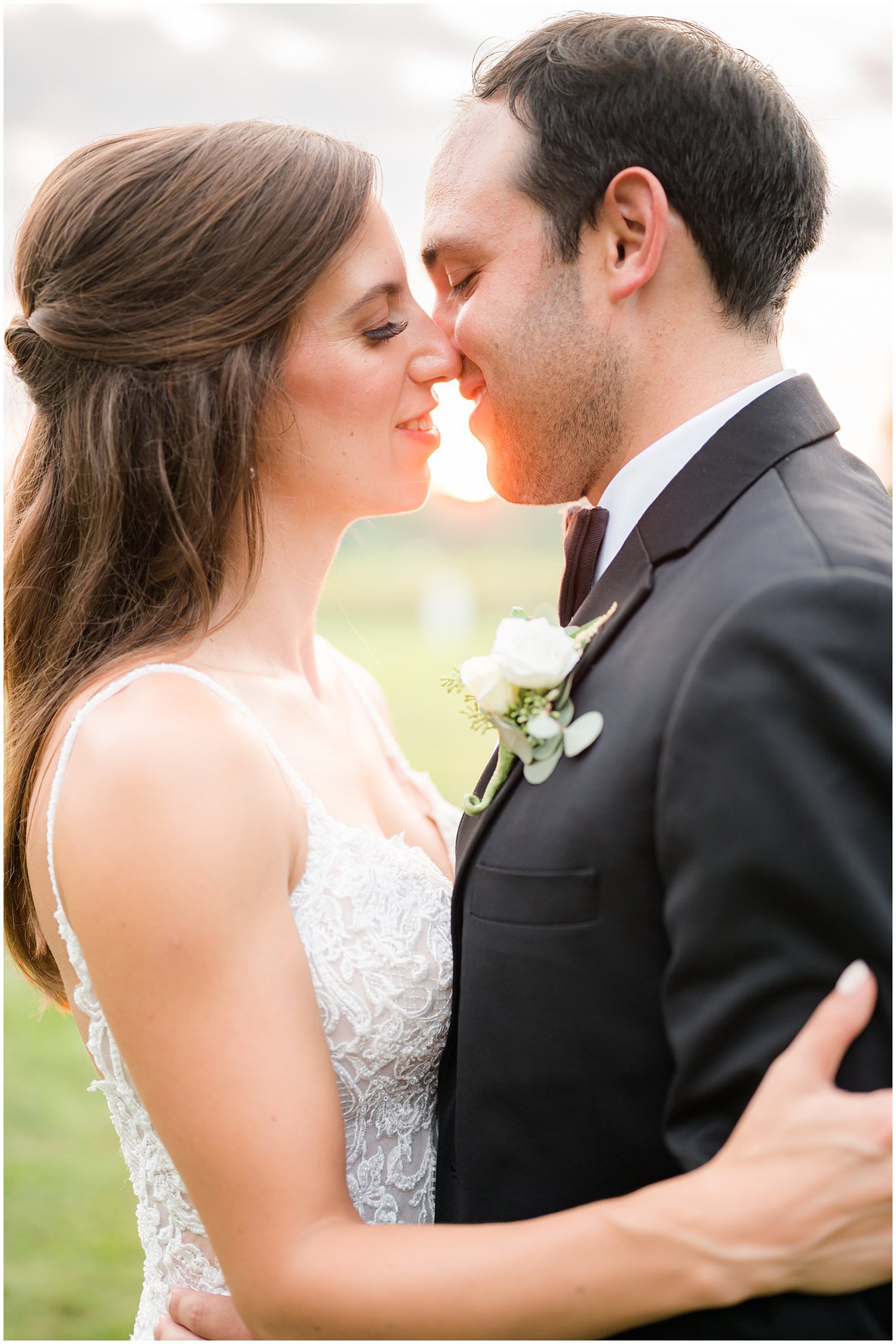 newlyweds kiss at sunset at the Inn at Fernbrook Farms