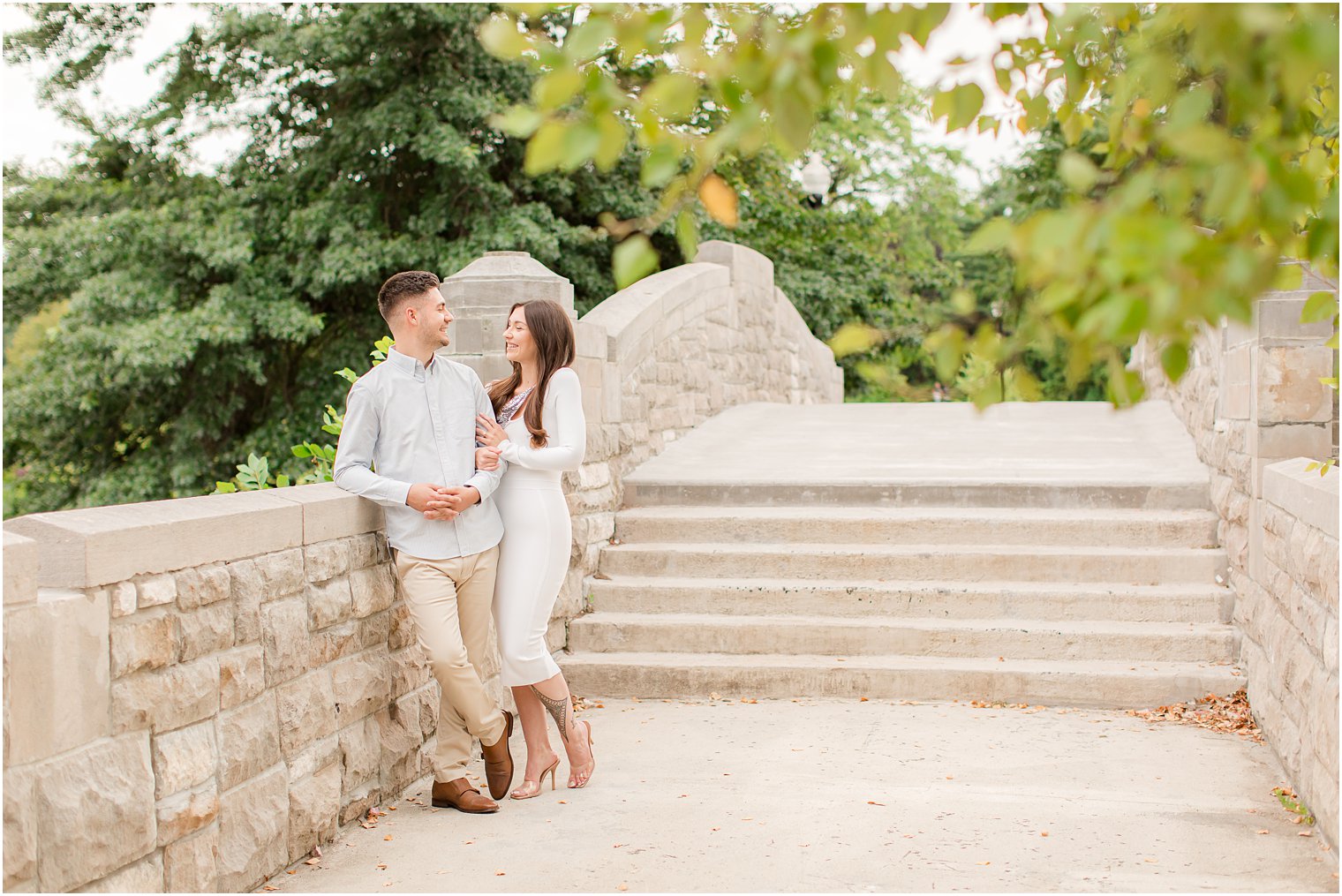 bride leans against groom during Verona Park engagement session