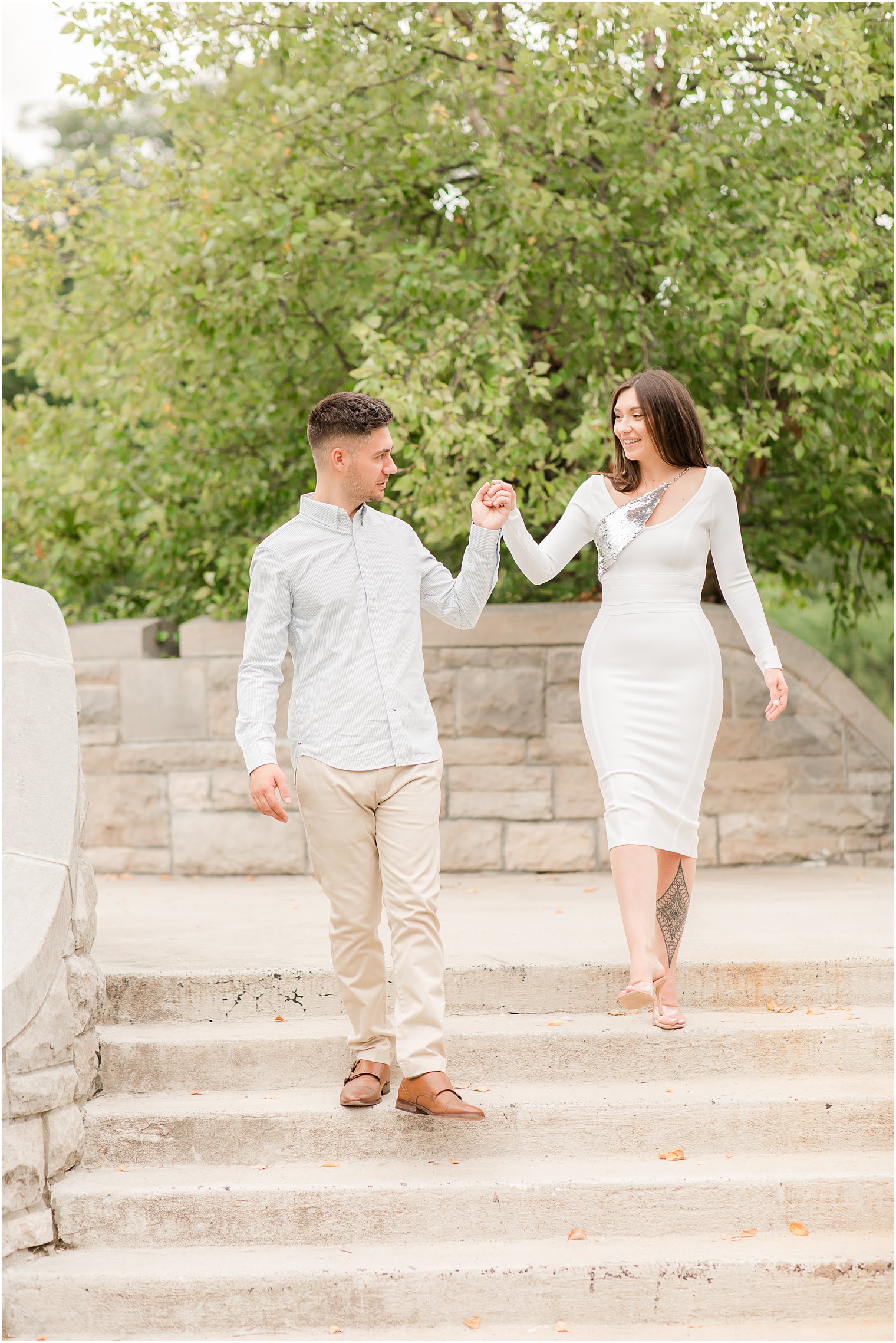 bride and groom walk down steps during Verona Park engagement session