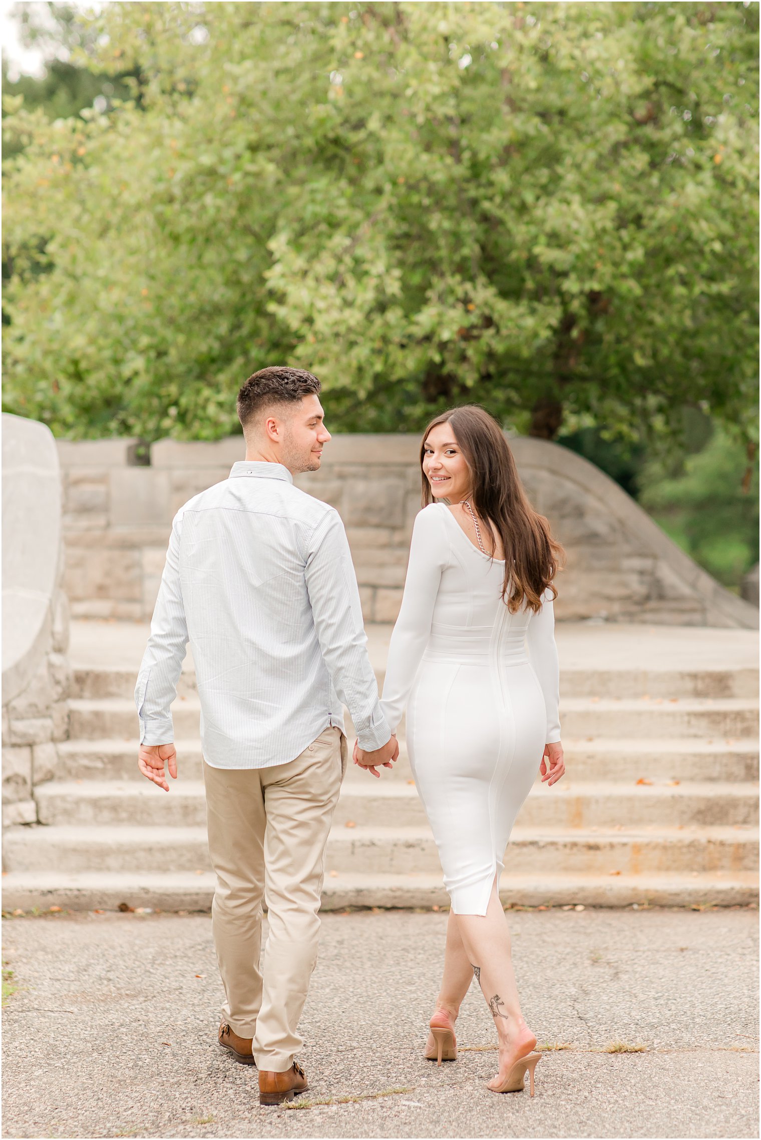 bride and groom hold hands walking up steps at Verona Park 