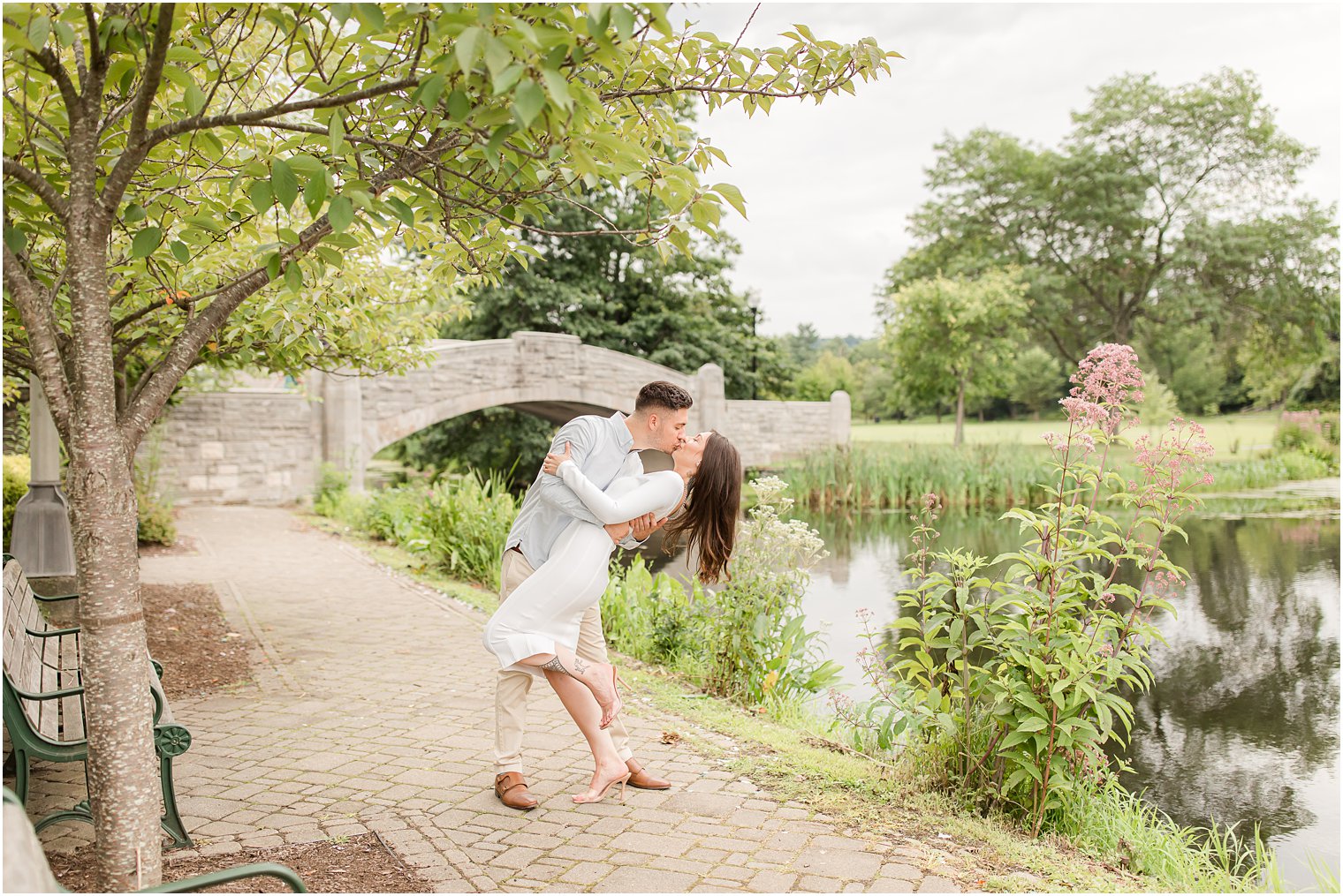 groom dips bride by water in Verona Park