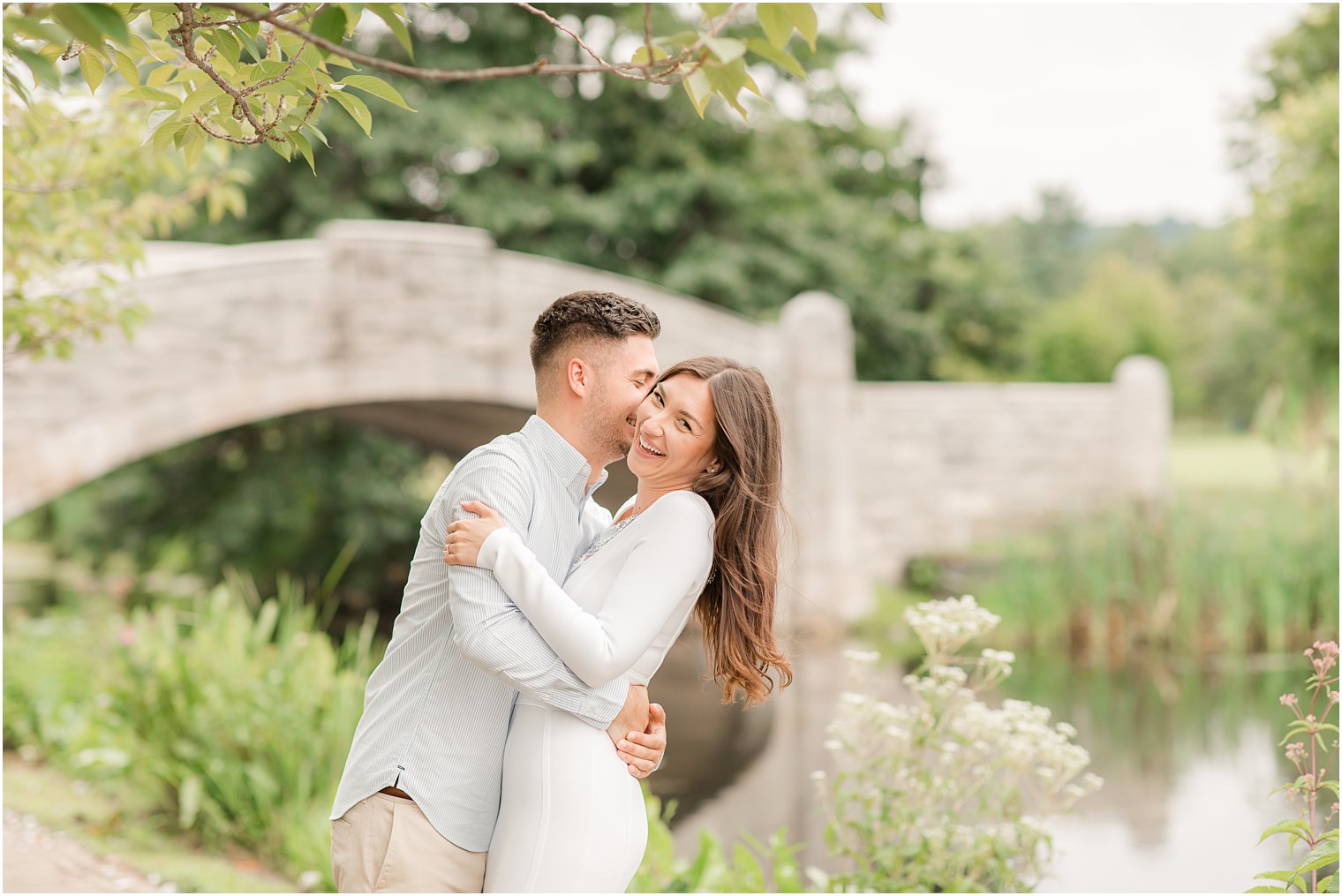 groom nuzzles bride's cheek during Verona Park engagement session