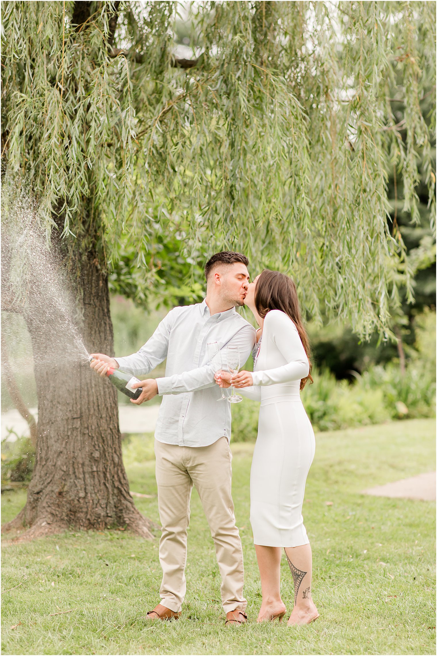 bride and groom kiss during champagne toast