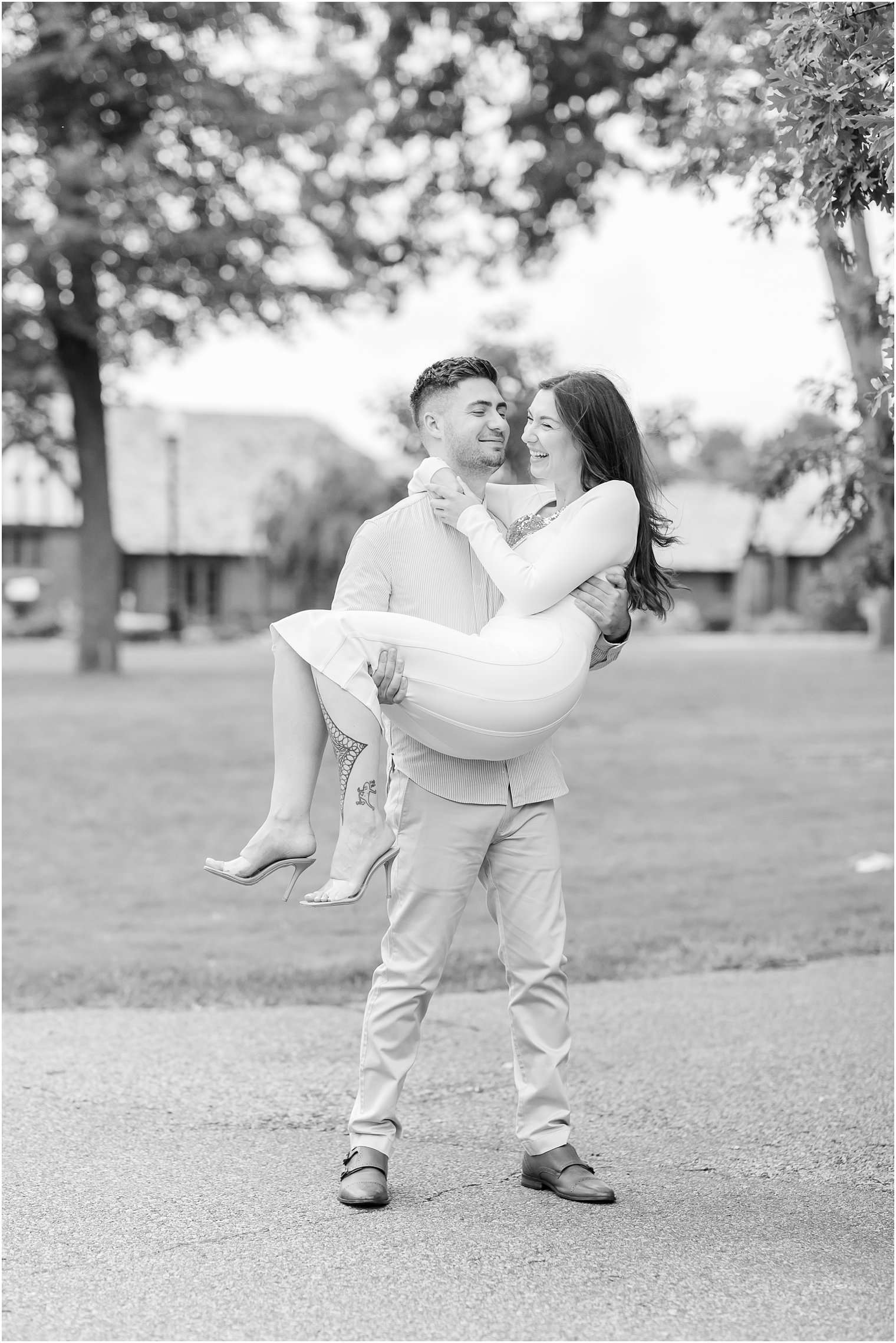 groom lifts bride up during Verona Park engagement session