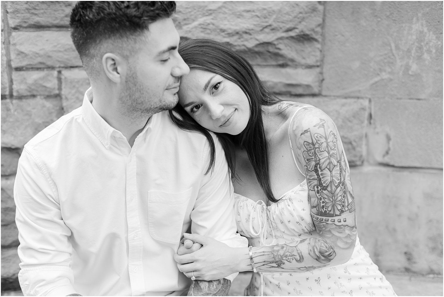 bride holds onto groom's arm during Verona Park engagement session
