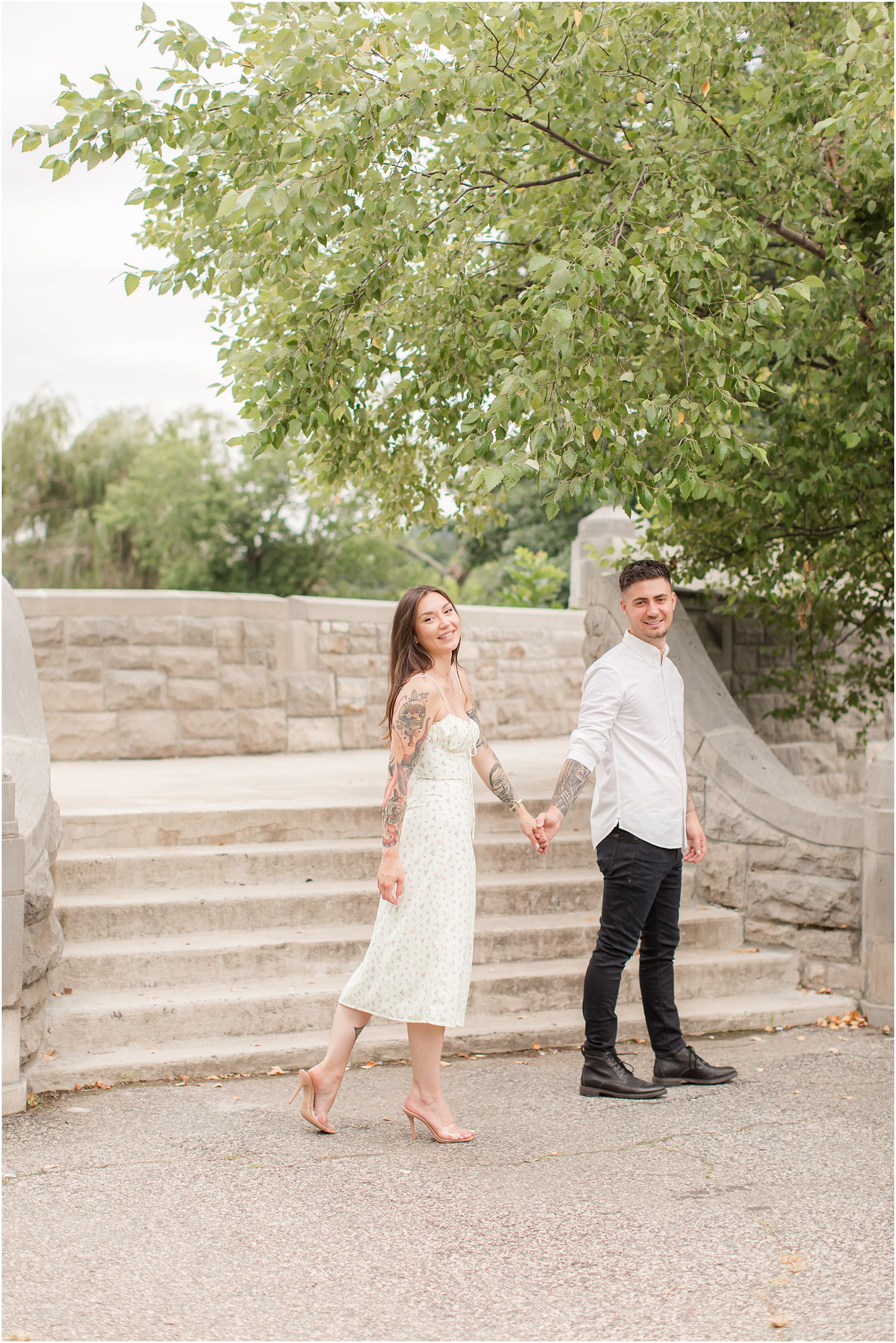 engaged couple walks through Verona Park