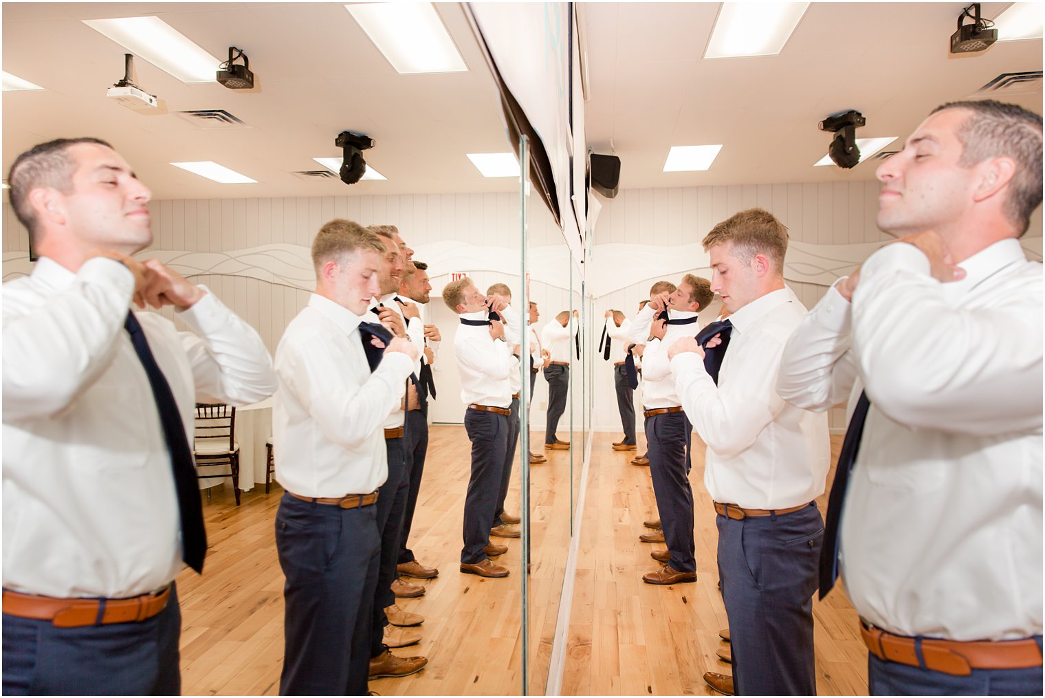 groomsmen prepare for NJ wedding day in mirror