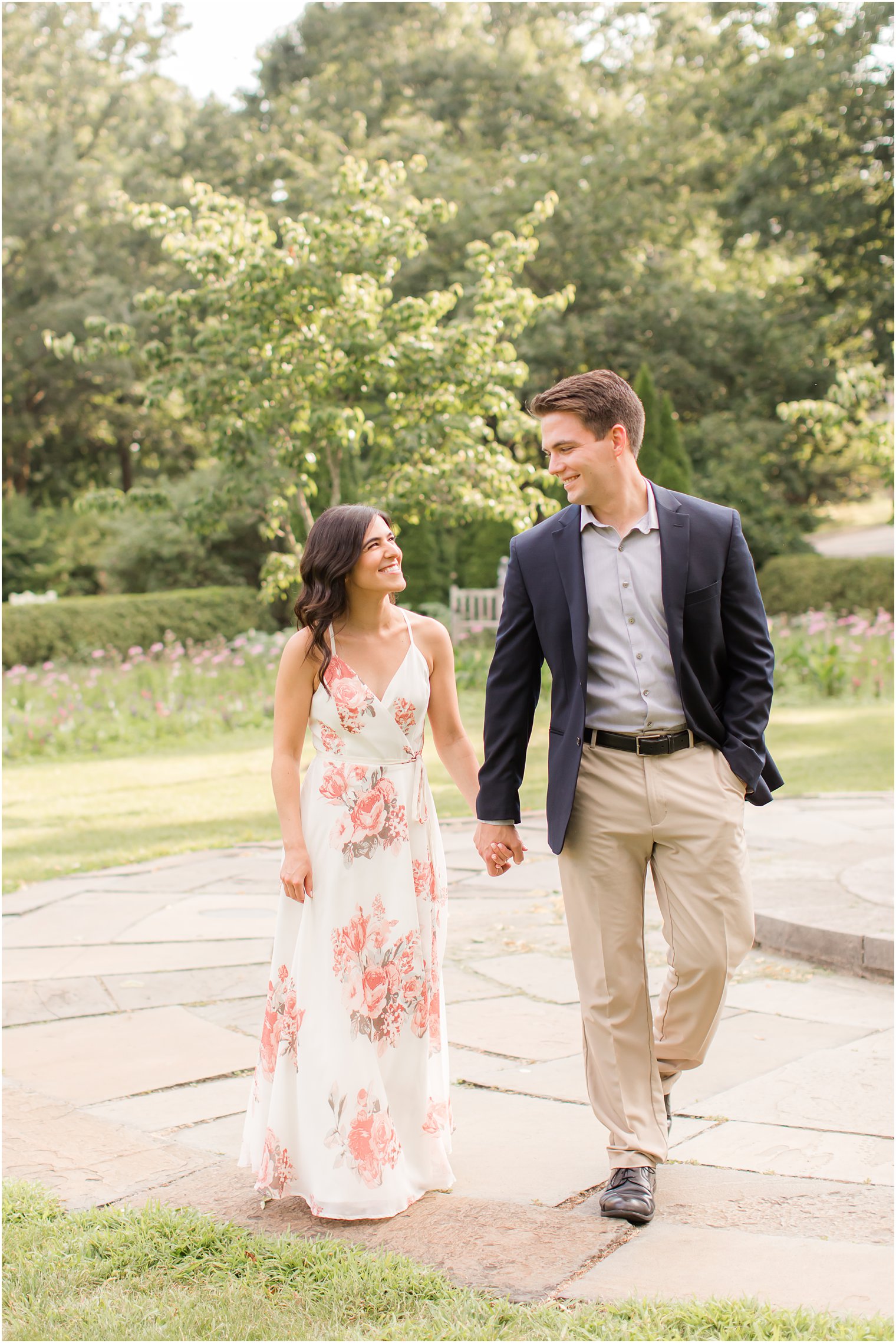 groom looks down at bridge during Skylands Manor engagement session