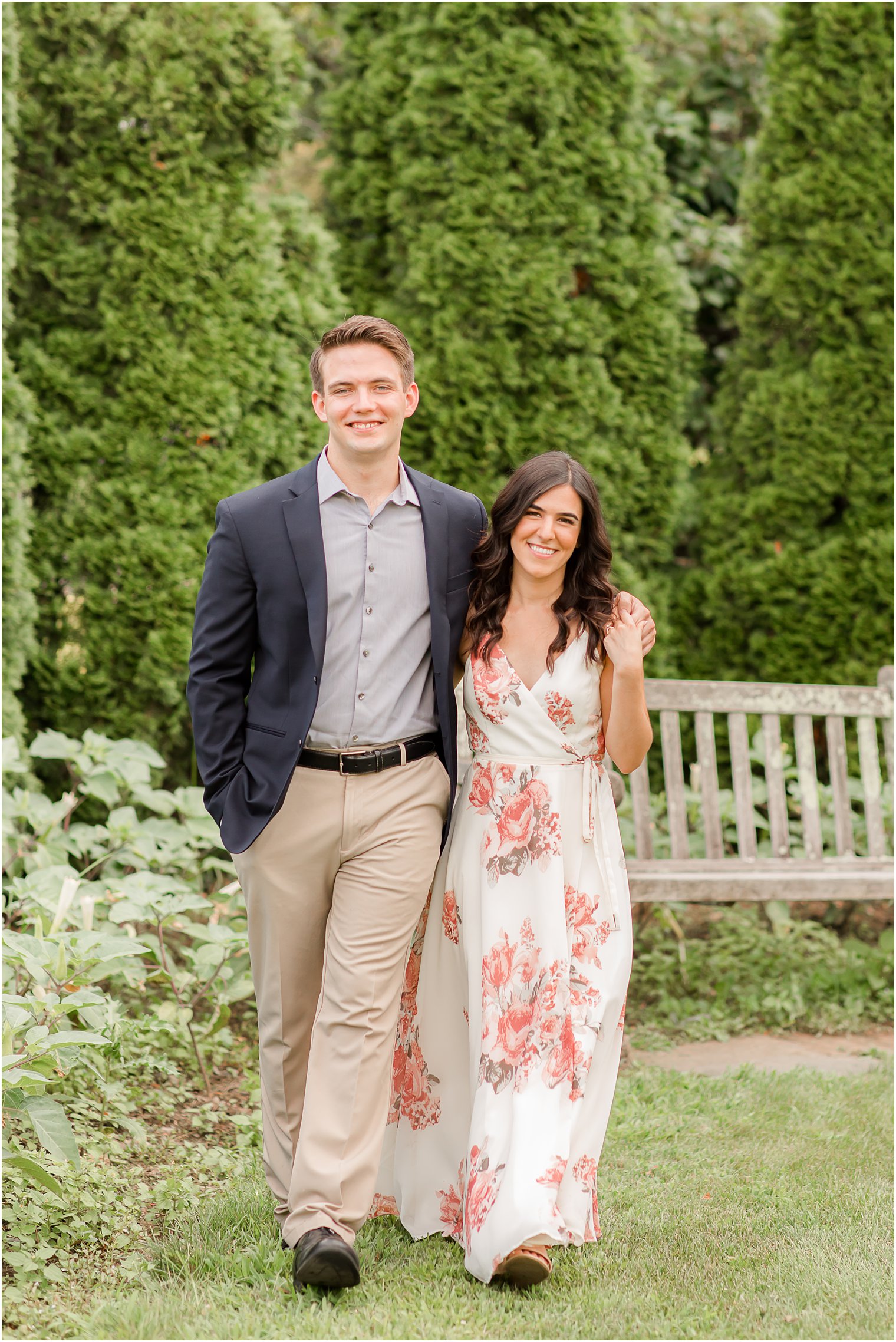 couple walks by bench during Skylands Manor engagement session