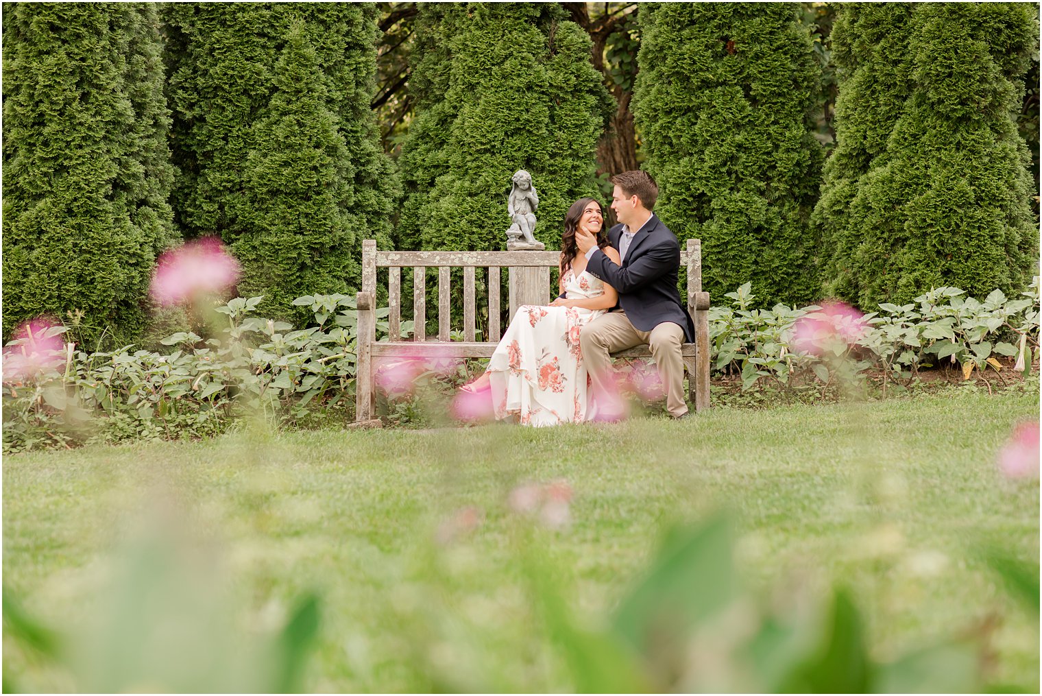 bride and groom sit on bench during Skylands Manor engagement session
