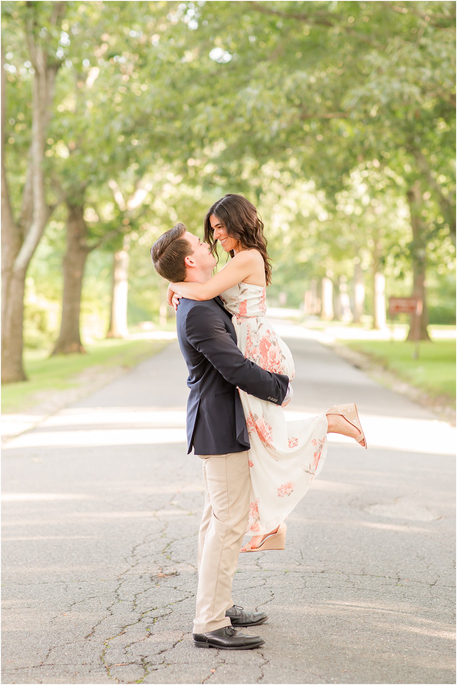 groom lifts bride on path during Skylands Manor engagement session