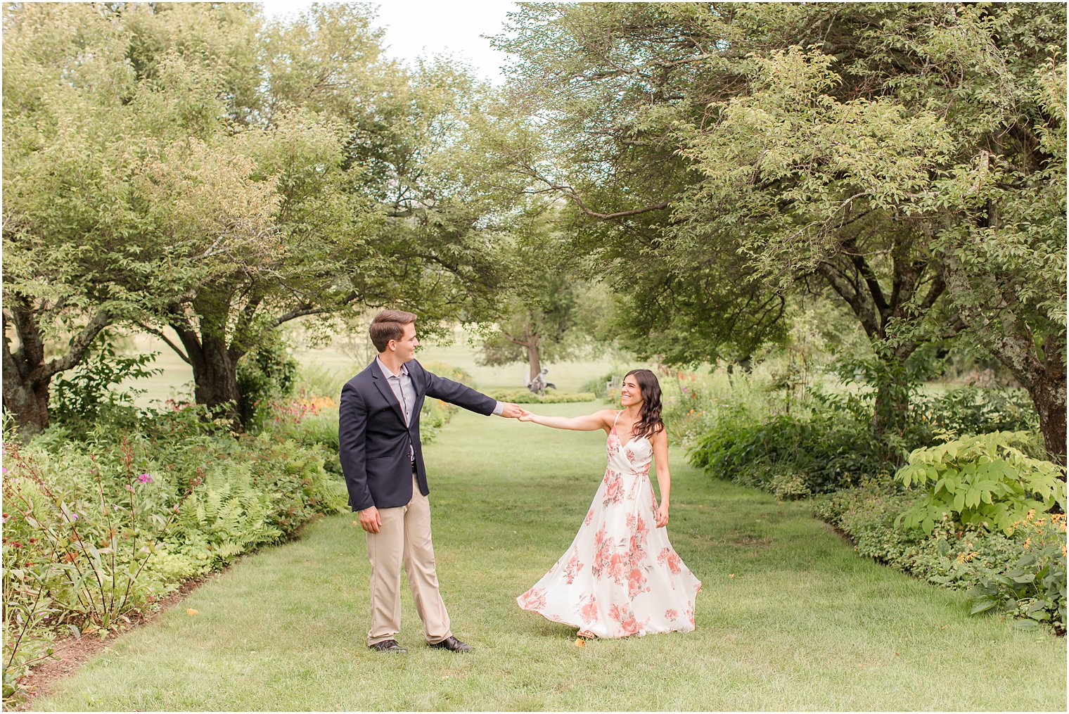 groom twirls bride during Skylands Manor engagement session