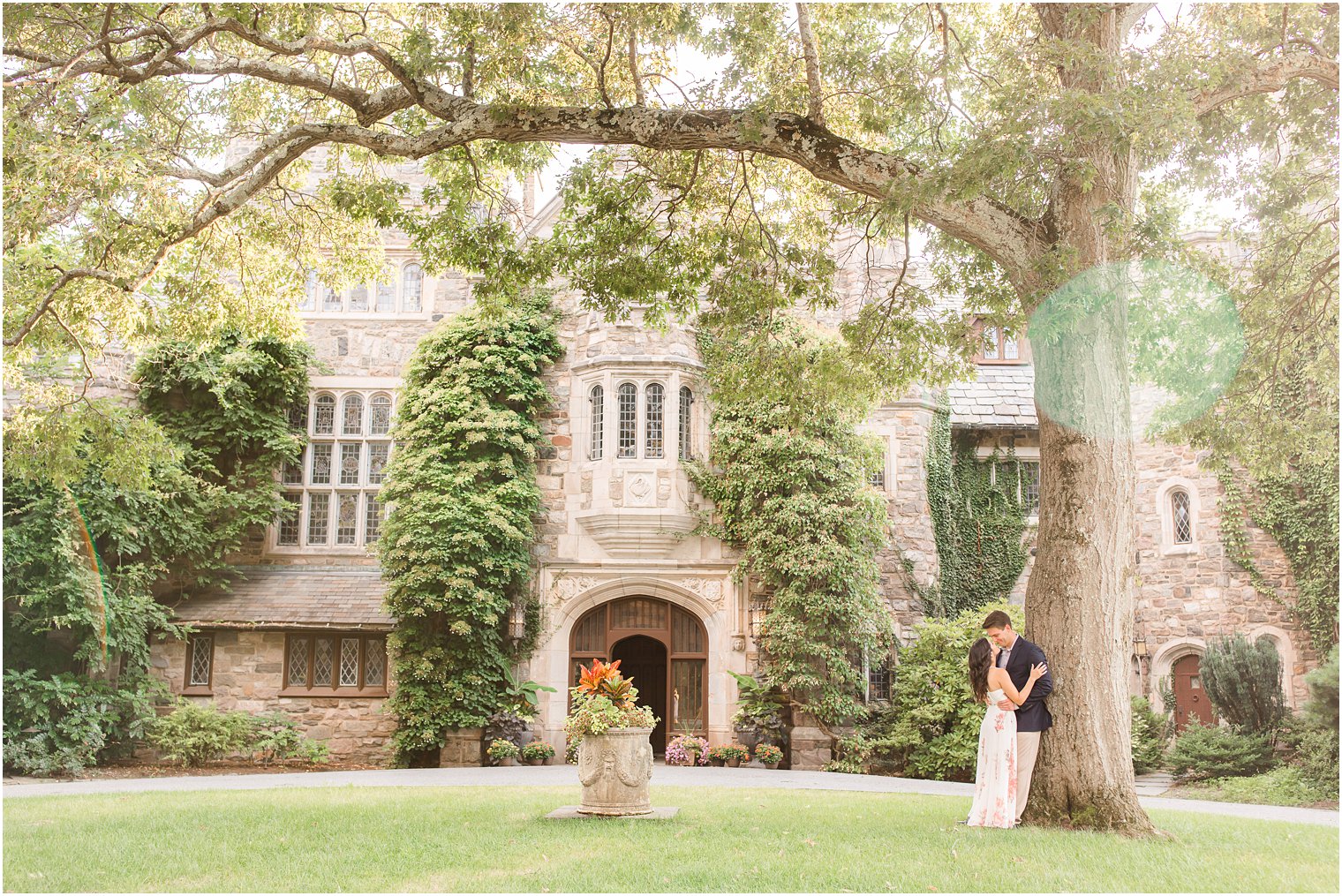 bride and groom lean against tree during Skylands Manor engagement session