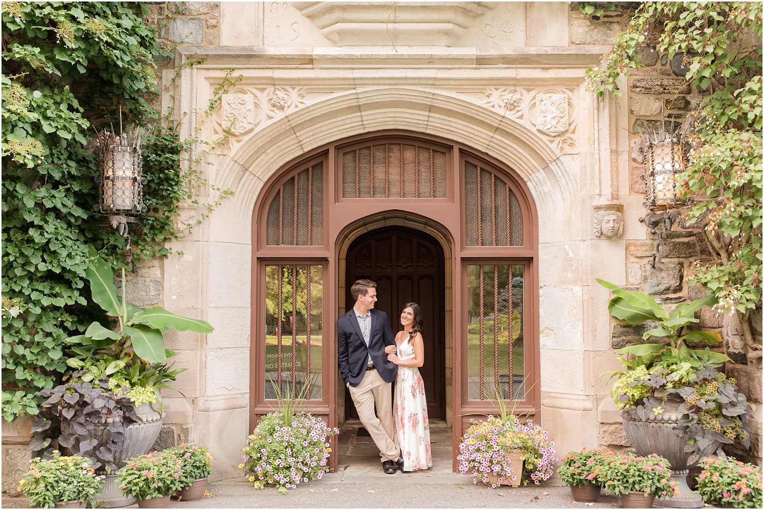 groom leans in doorway with bride during NJ engagement photos