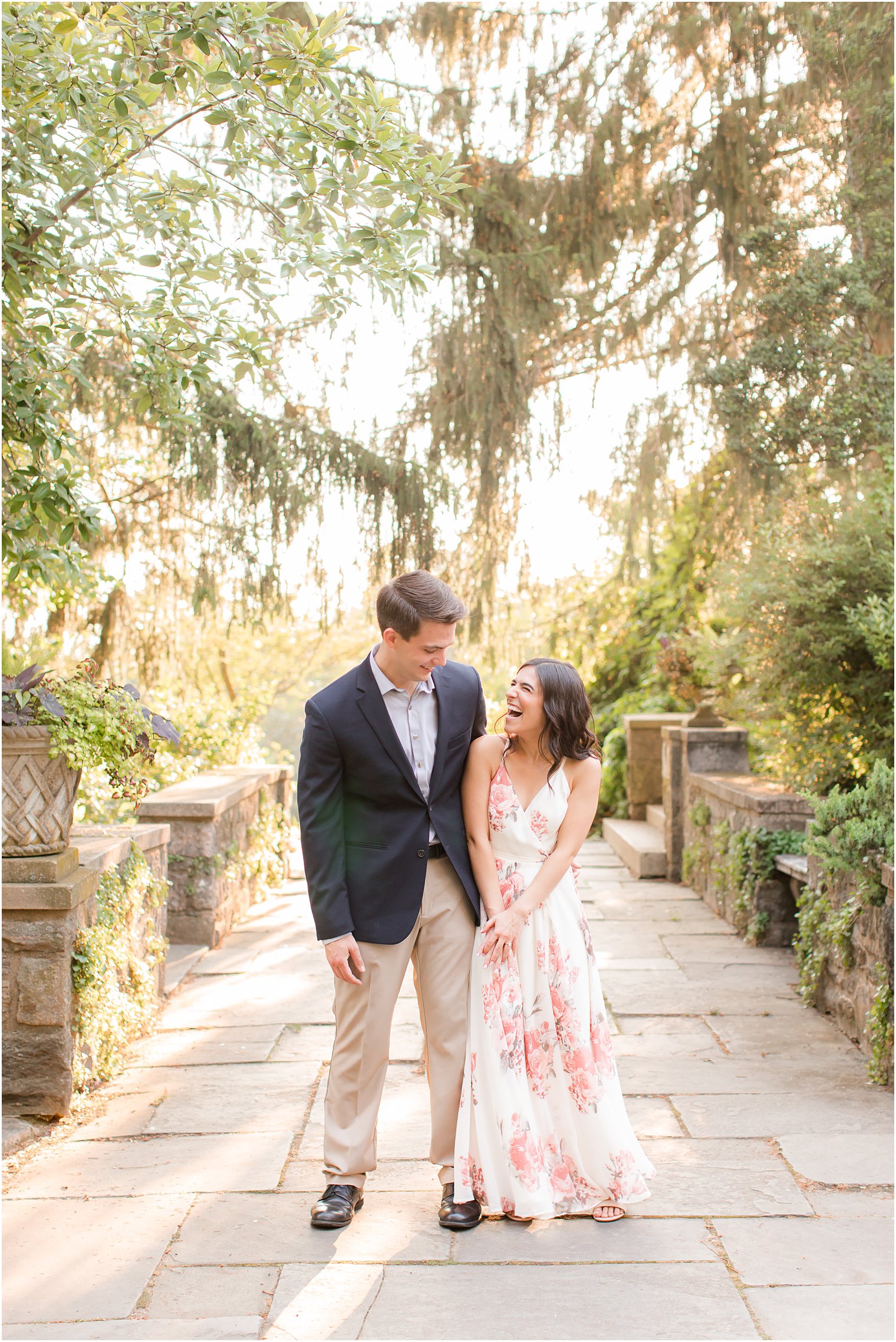 bride and groom laugh while bumping hips during NJ engagement photos