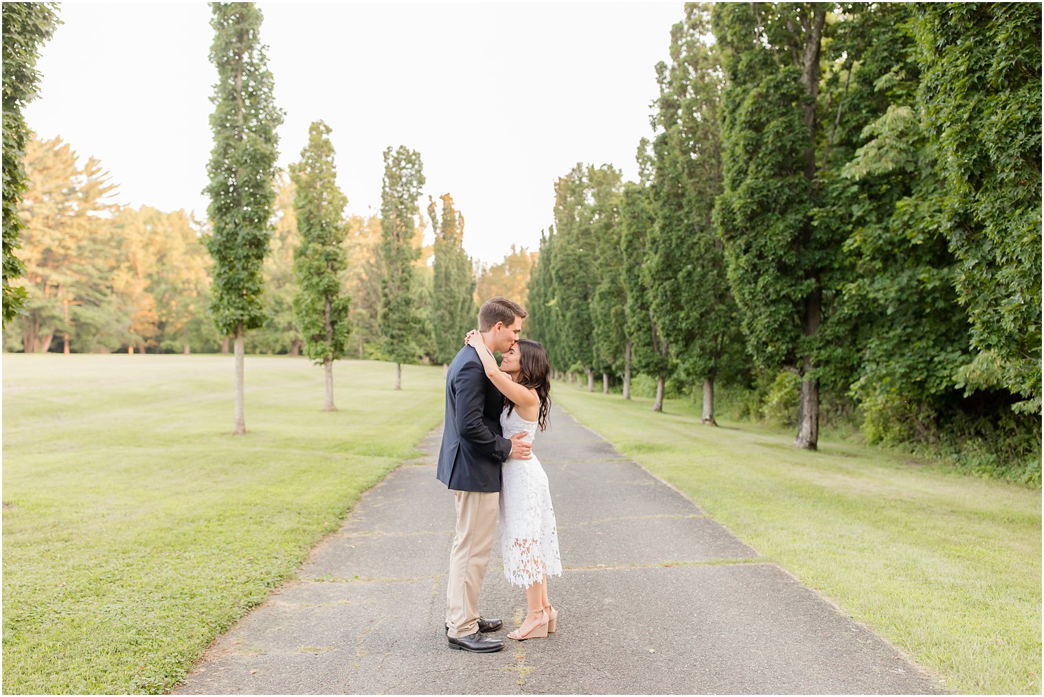 groom kisses bride's forehead during Skylands Manor engagement session