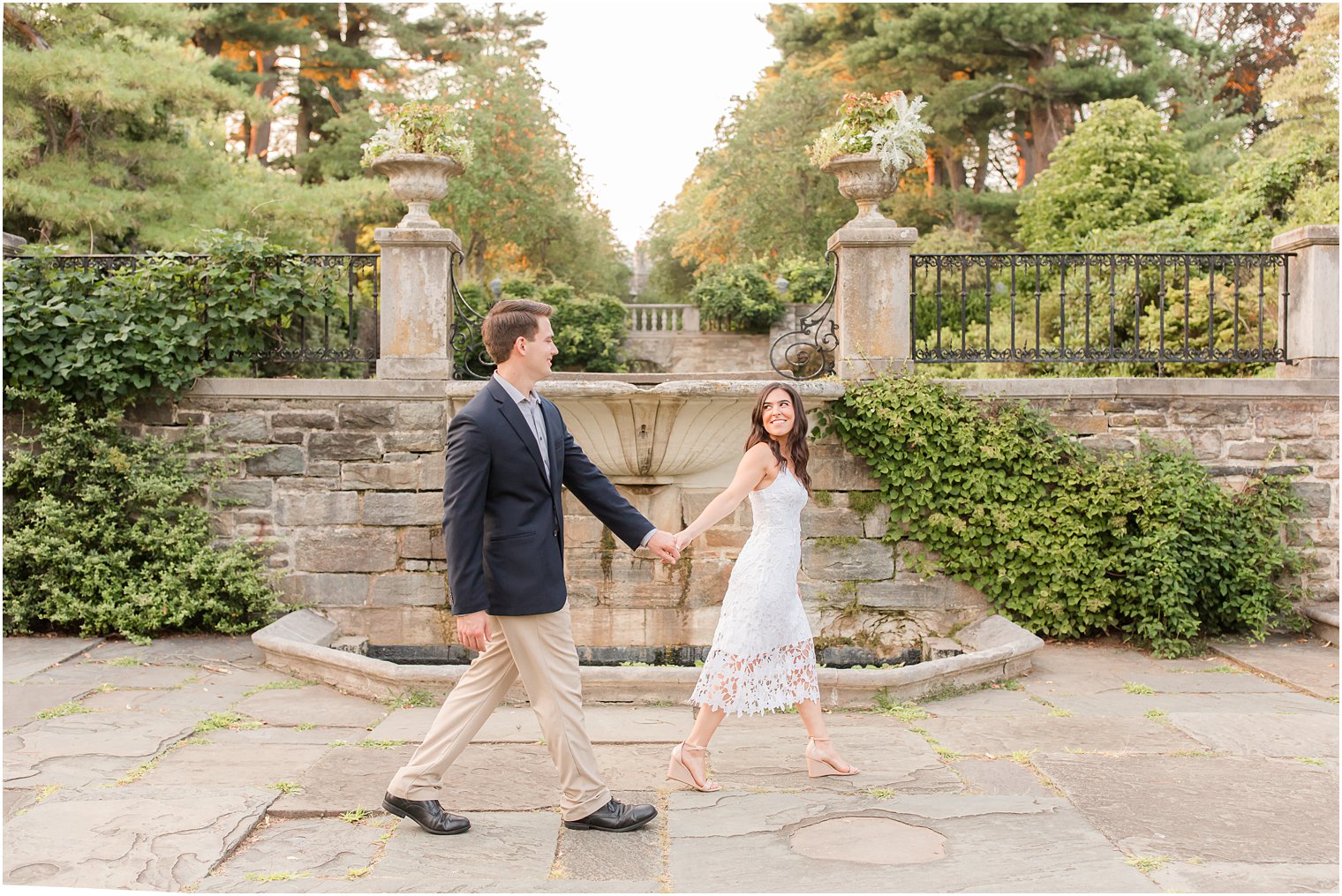 bride and groom hold hands walking through Skylands Manor 
