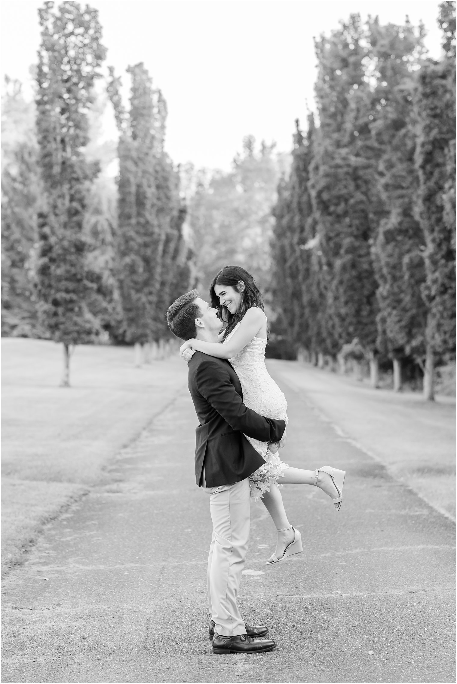 groom lifts bride on path during Skylands Manor engagement session