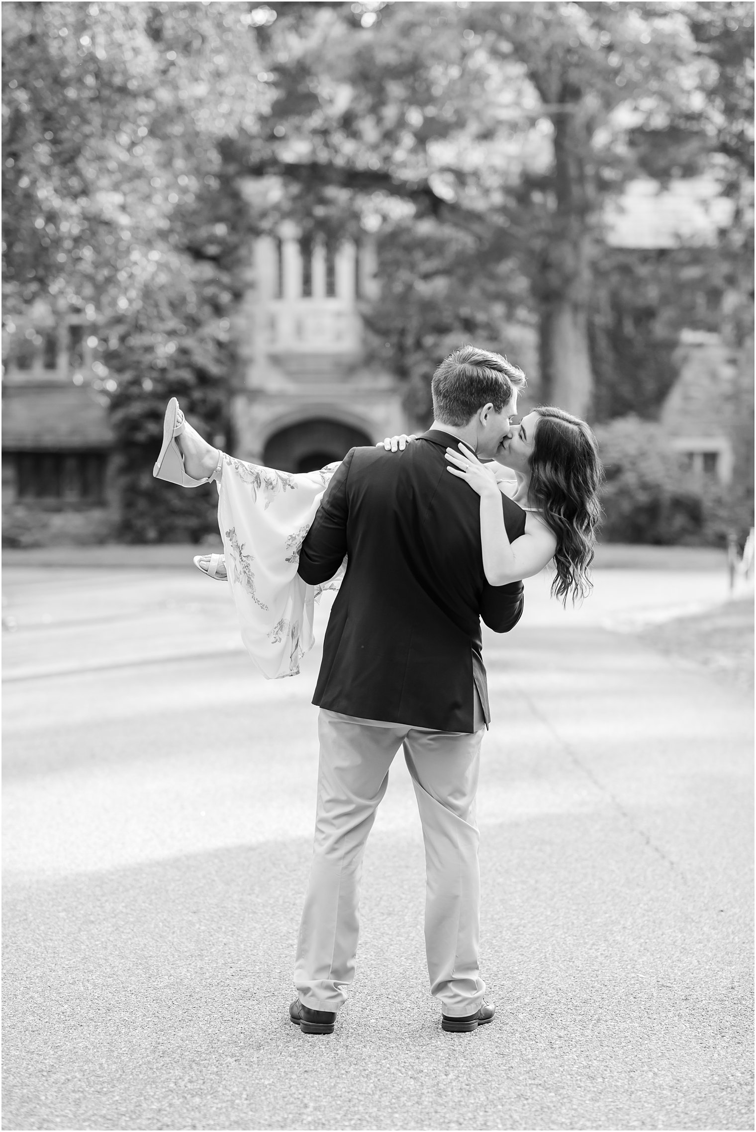 groom holds bride while kissing her during Skylands Manor engagement session