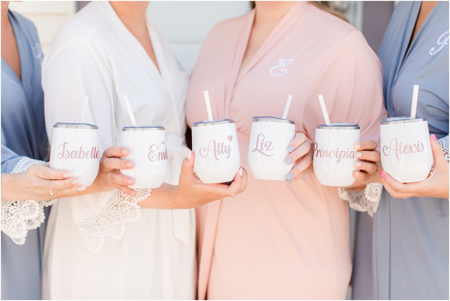bridesmaids hold matching cups on wedding day