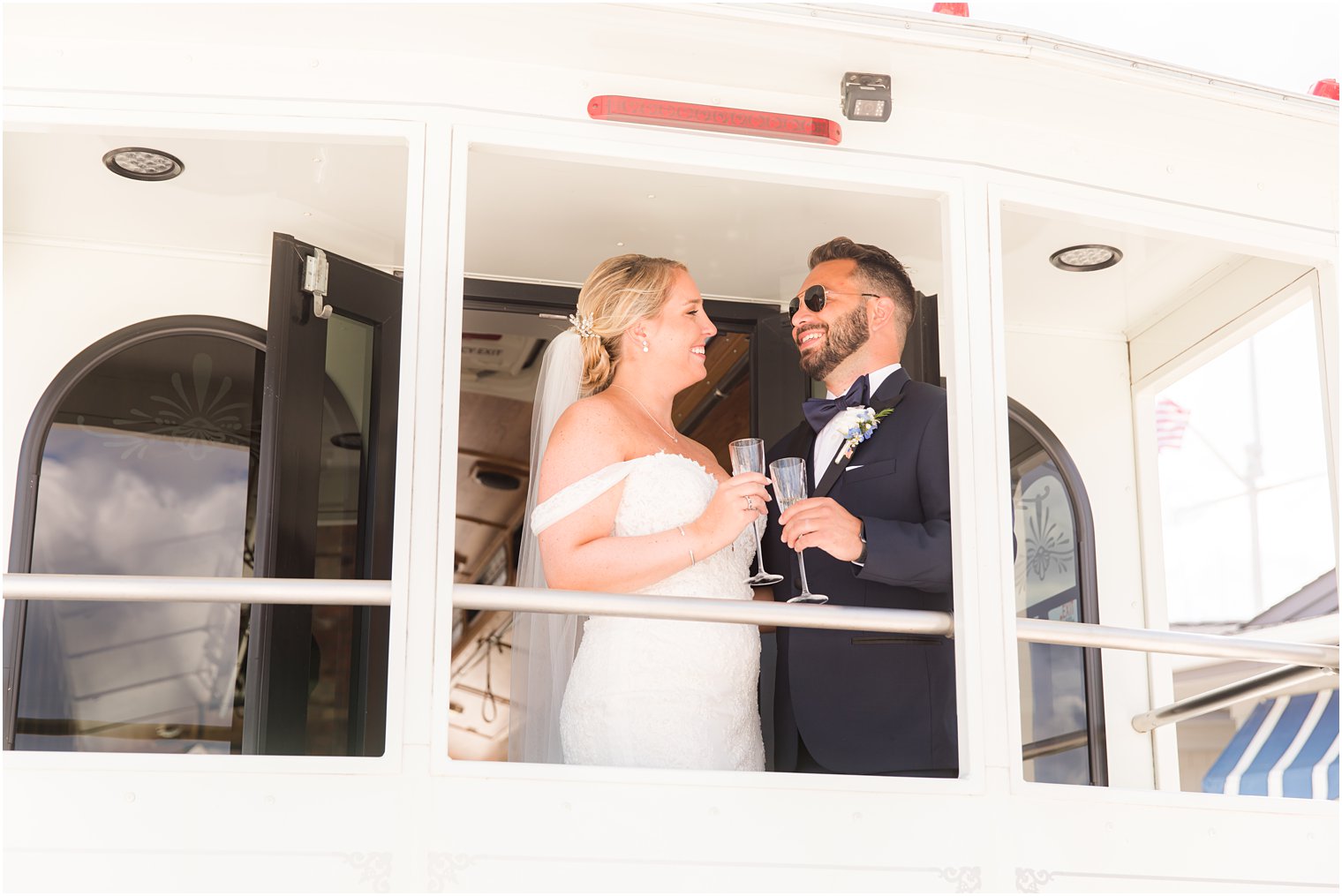 newlyweds toast champagne on back of trolley on Long Beach Island