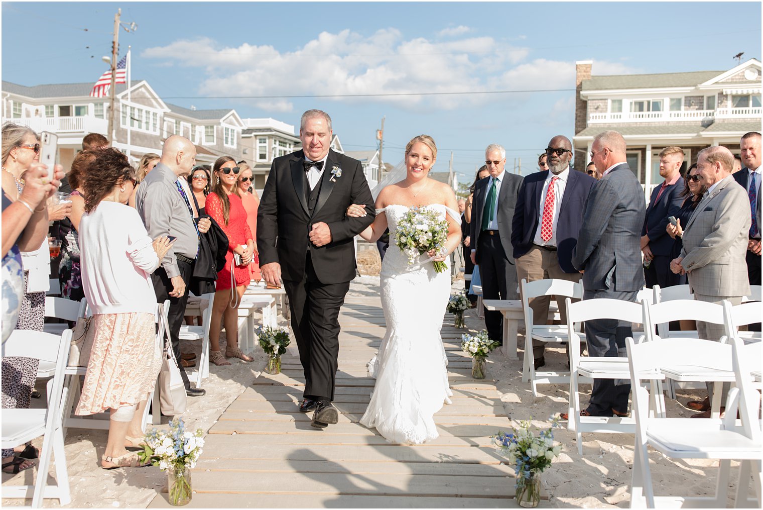 bride and dad walk down aisle at waterfront beach ceremony in New Jersey 