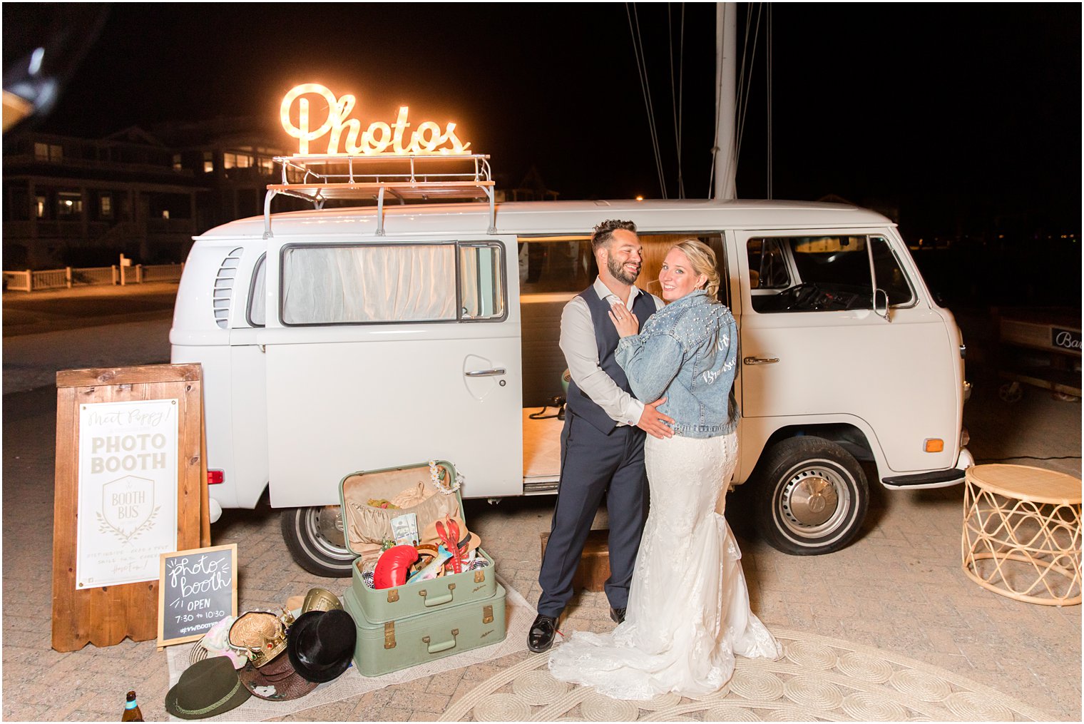 newlyweds pose outside photo booth at Brant Beach Yacht Club