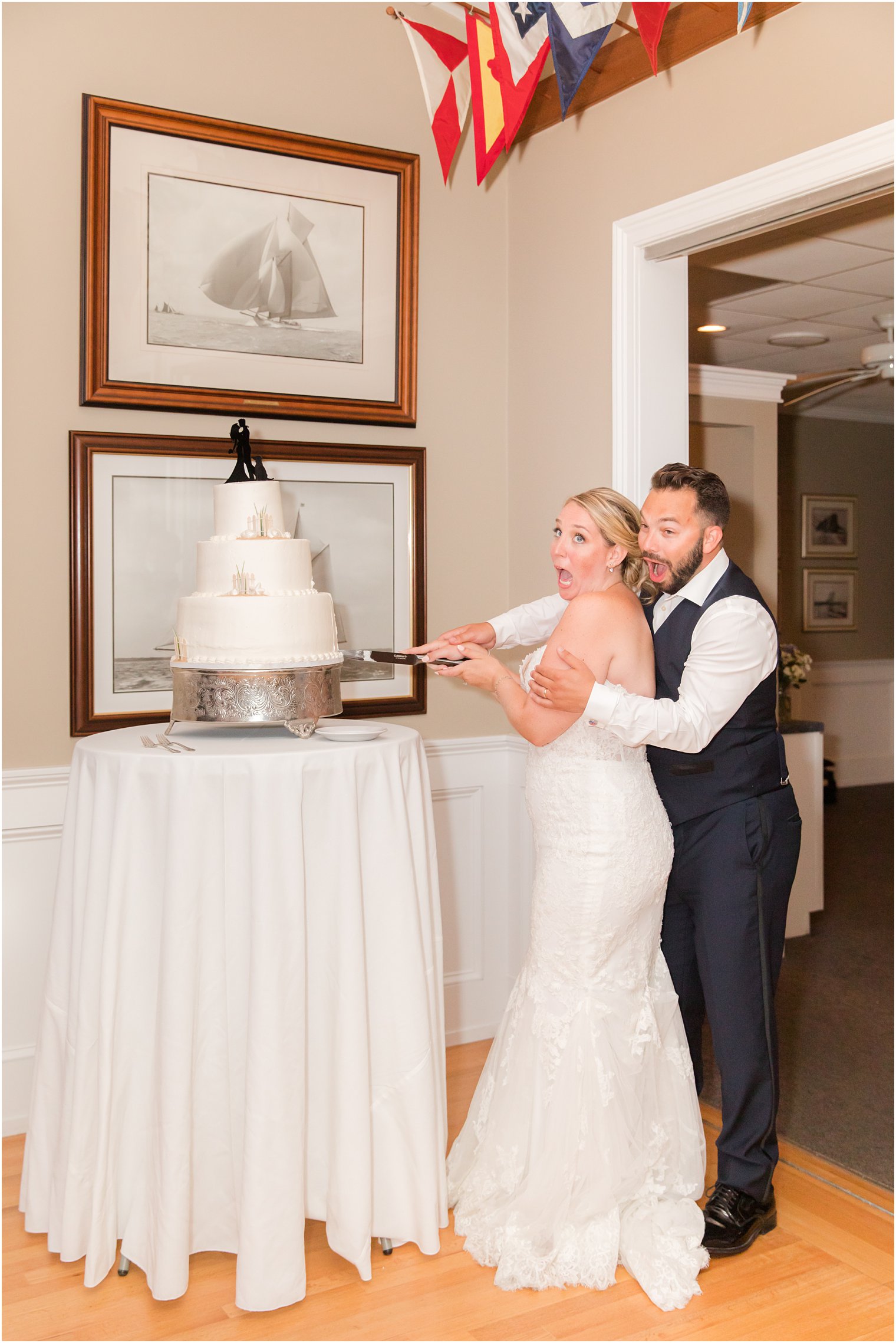 bride and groom cut wedding cake at Brant Beach Yacht Club