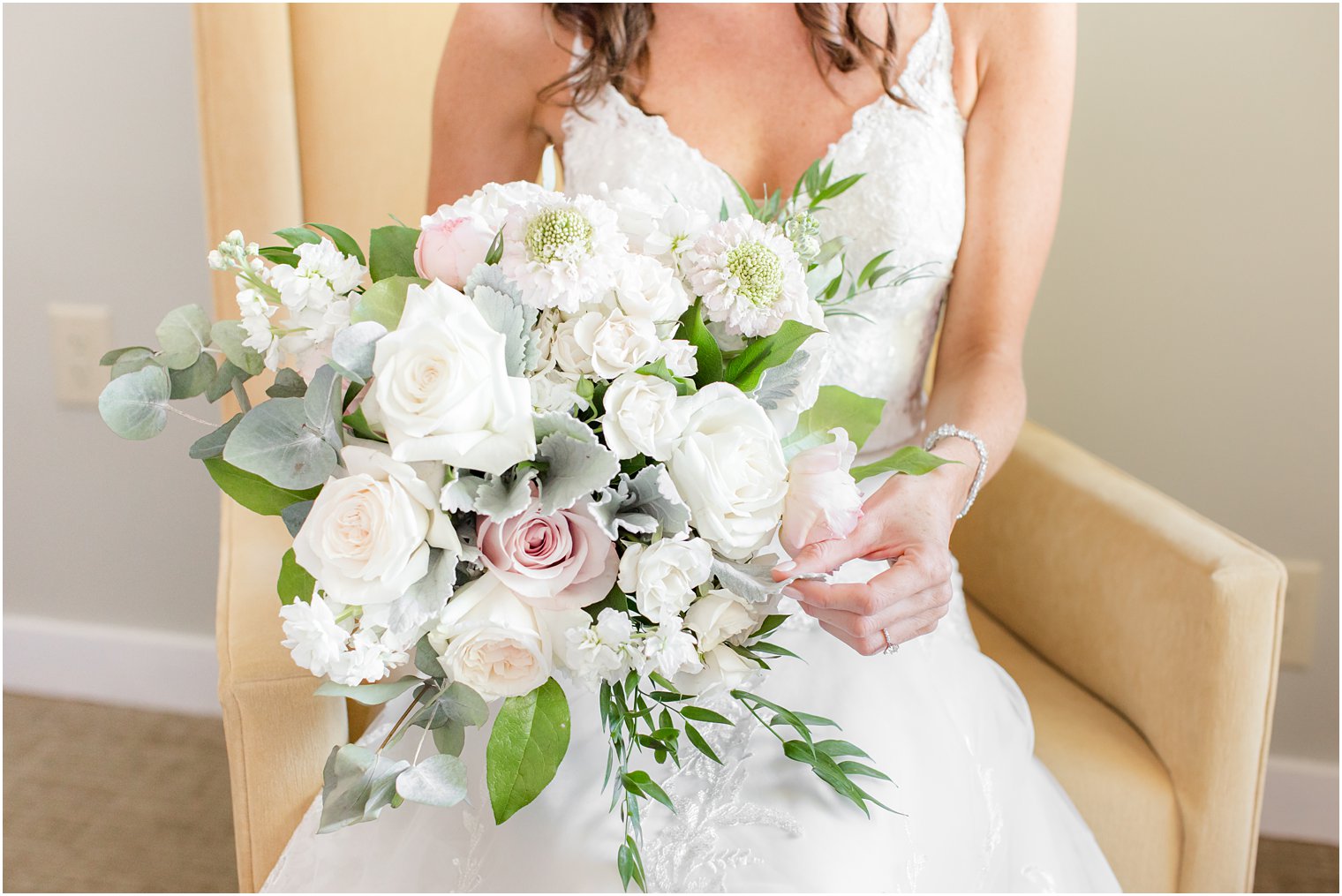 bride holds bouquet with white and pink roses for Princeton NJ wedding day 