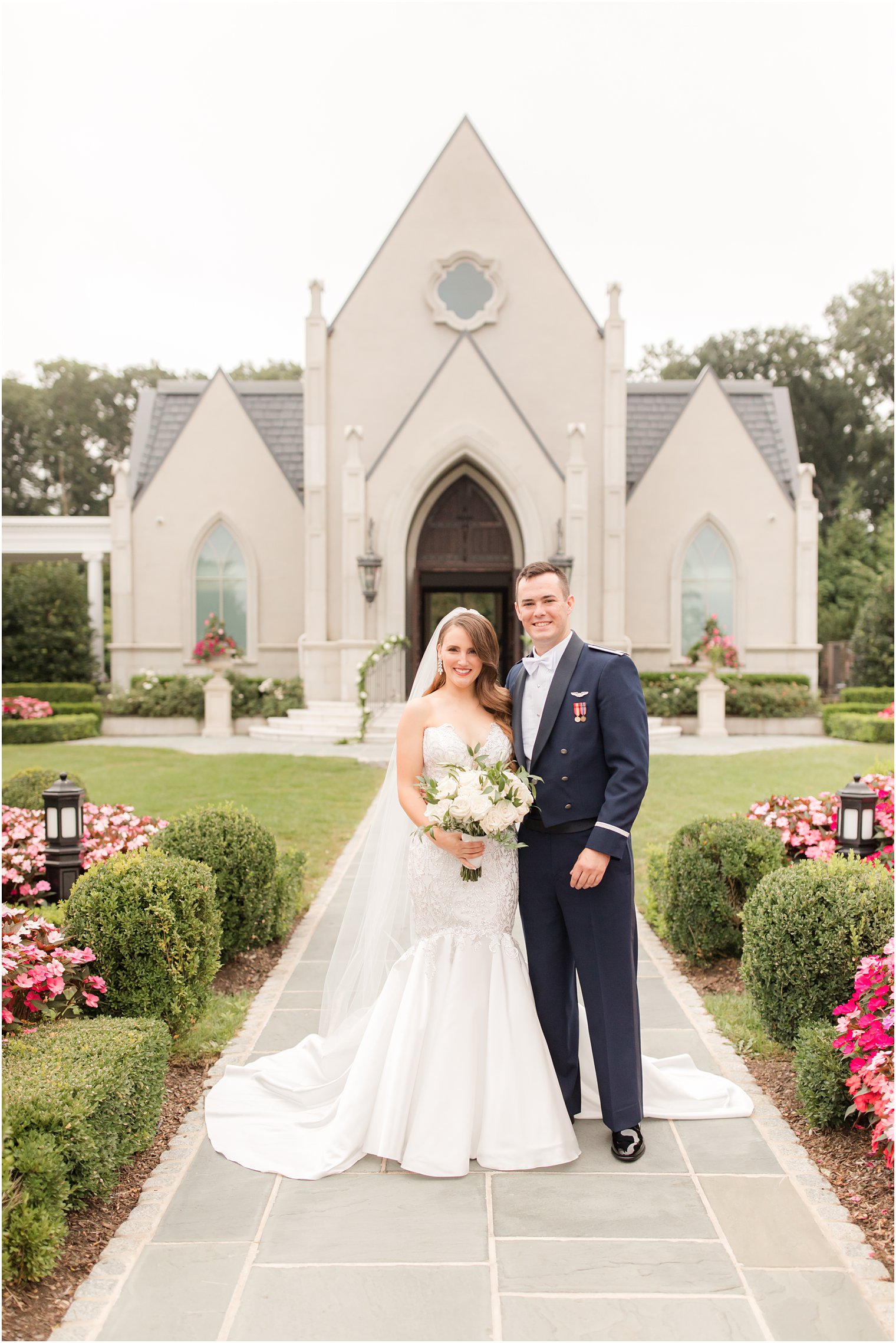 bride and groom pose outside chapel of Park Chateau Estate