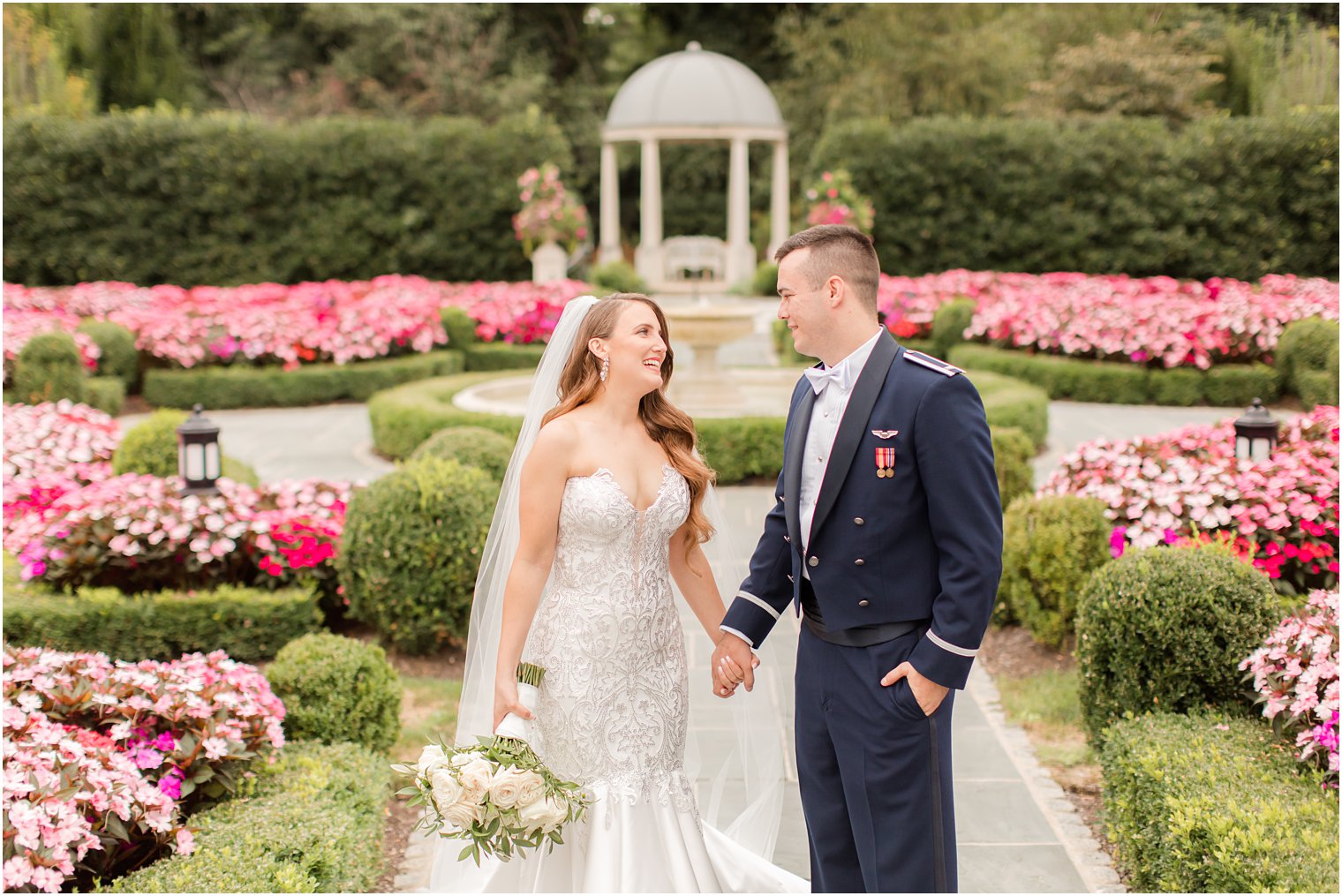 bride and groom walk through gardens at Park Chateau Estate