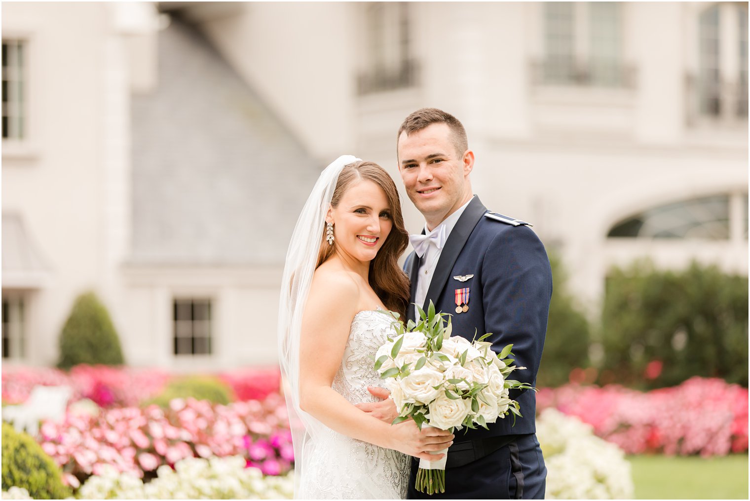 newlyweds hug on lawn at Park Chateau Estate