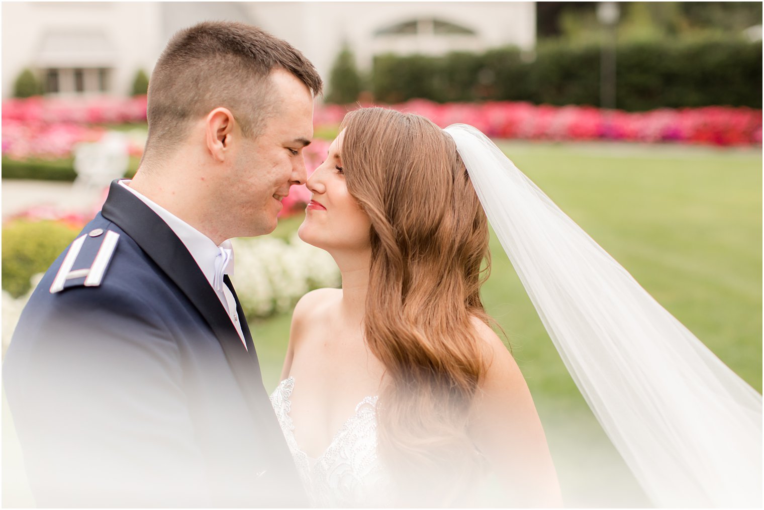 newlyweds pose touching noses on lawn of Park Chateau Estate